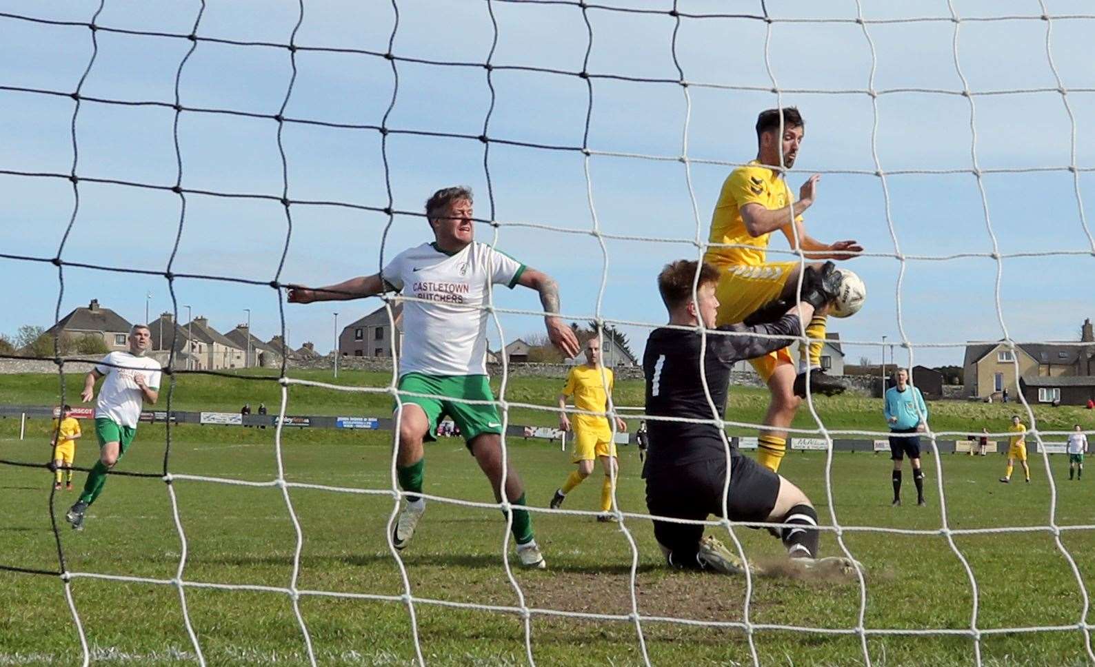 Castletown goalkeeper Ewan Grant saves from Staxigoe United striker Graham MacNab during Saturday's 0-0 draw at Harmsworth Park in CAFA Division One. Picture: James Gunn