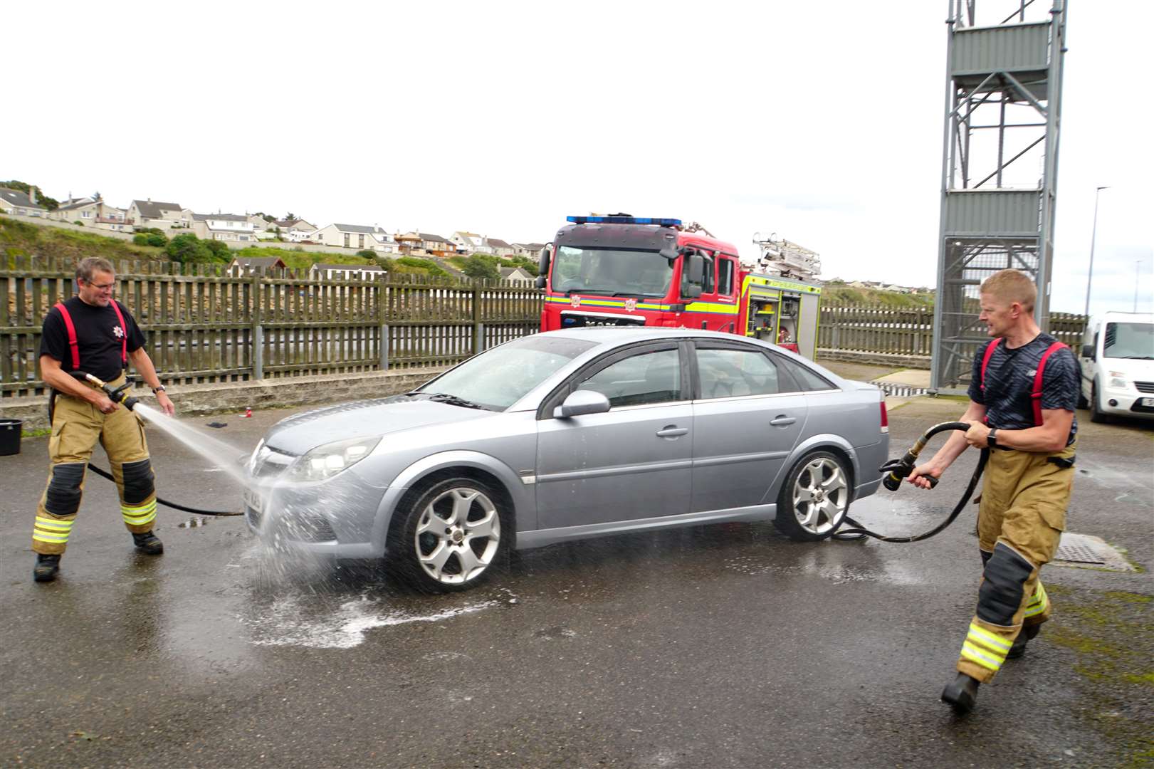 What better way to clean a car than with a fireman's hose?