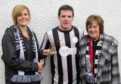 Man-of-the-match Davie Allan receives his award from Siony Swanson and Anne Campbell, on behalf of match sponsor Wick High School social committee.