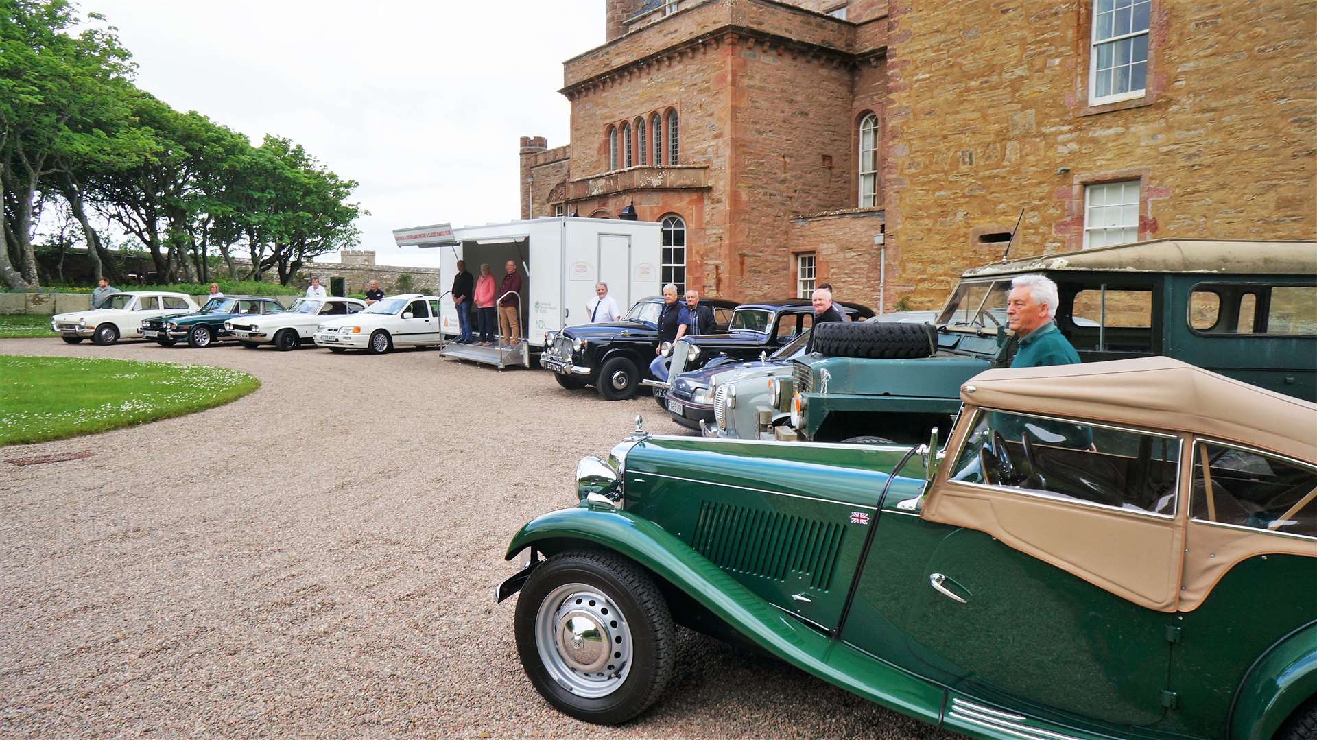 Members of the Caithness and Sutherland Vintage and Classic Vehicle Club line up with their cars at the front of the Castle of Mey on Sunday morning.