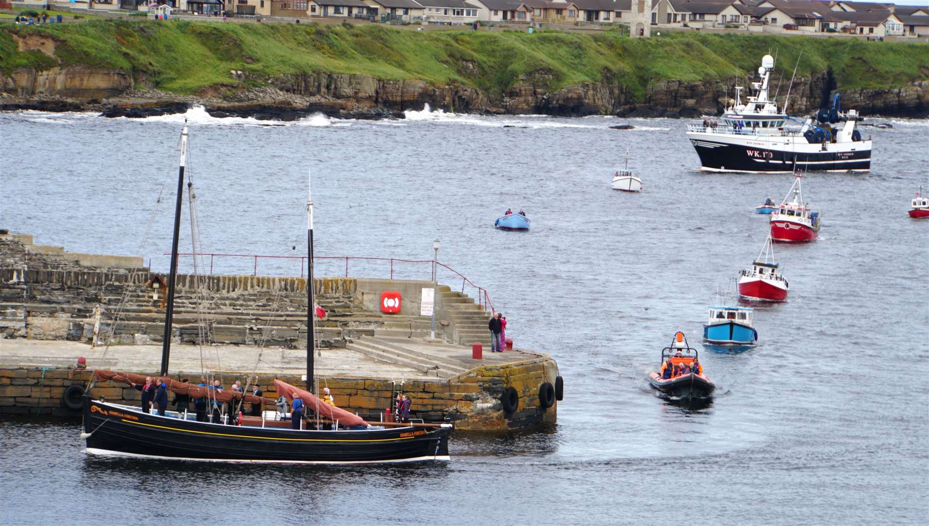 The Isabella Fortuna and other boats returning to Wick harbour in August 2019 after the Black Saturday commemoration organised by the Seafarers Memorial Group. Picture: DGS