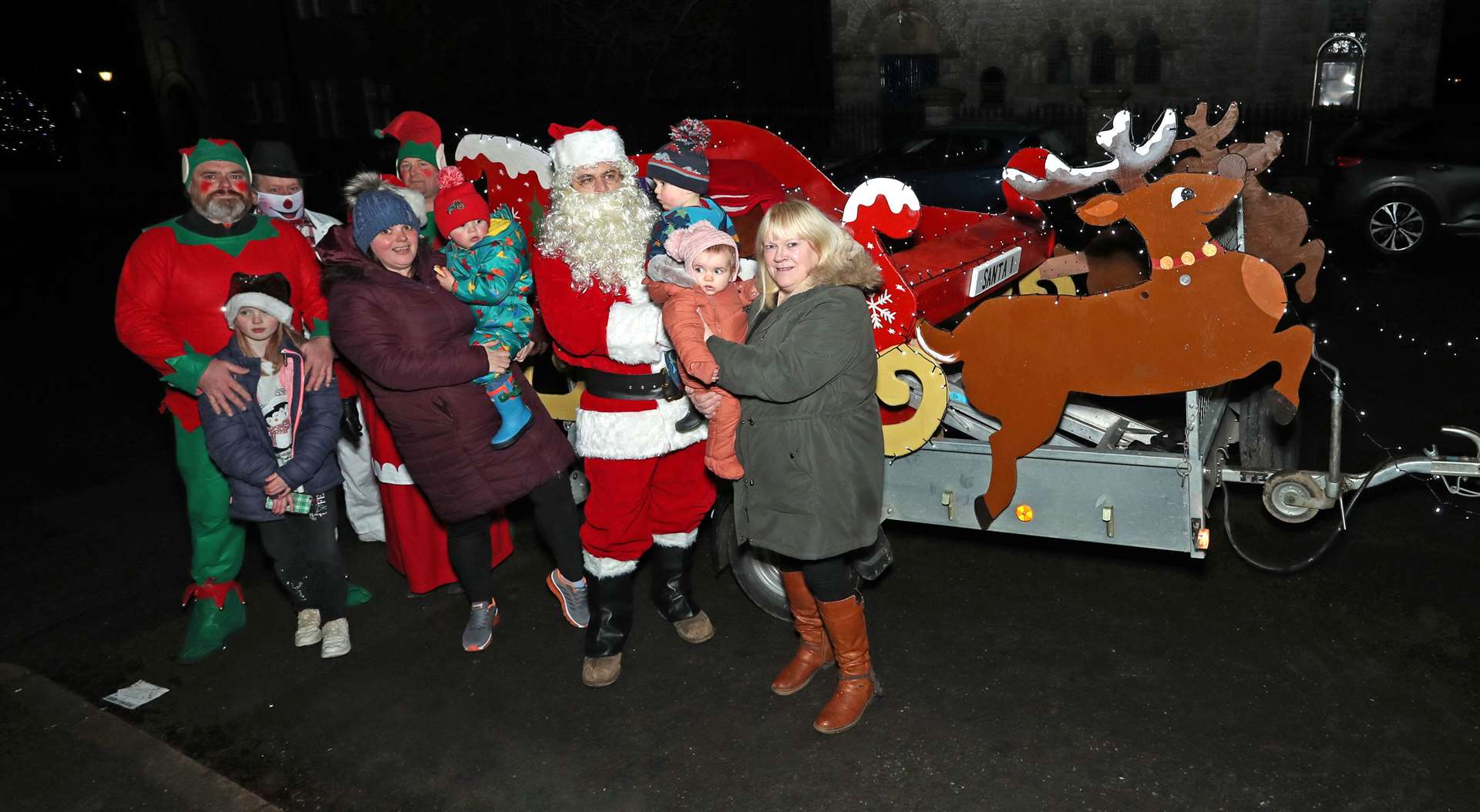 The first three youngsters line up with Santa, with Kayleigh Mackay and Mandy Craigie (right) of the Halkirk shop Splurge who donated the sweets that Santa gave to every child. He also gave bottled drinks courtesy of T&B Catering. Picture: James Gunn