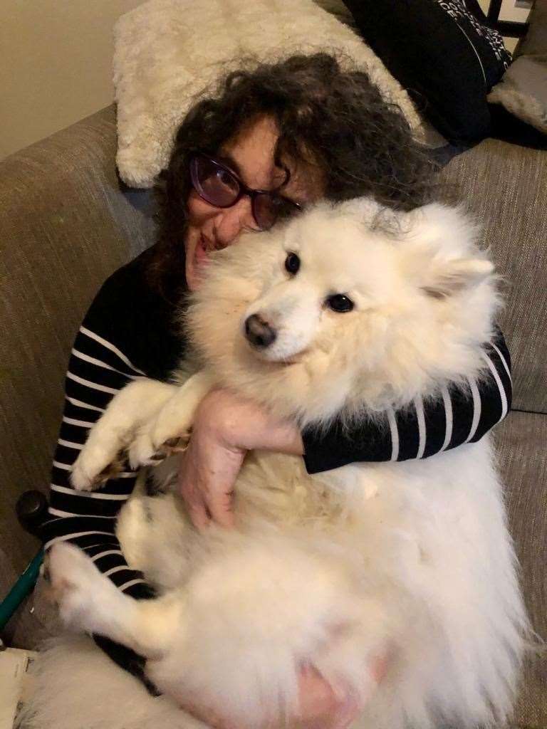 Indra Joyce with the family’s dog, a 12-year-old Japanese Spitz named Charlie (@Indra68/Twitter/PA)