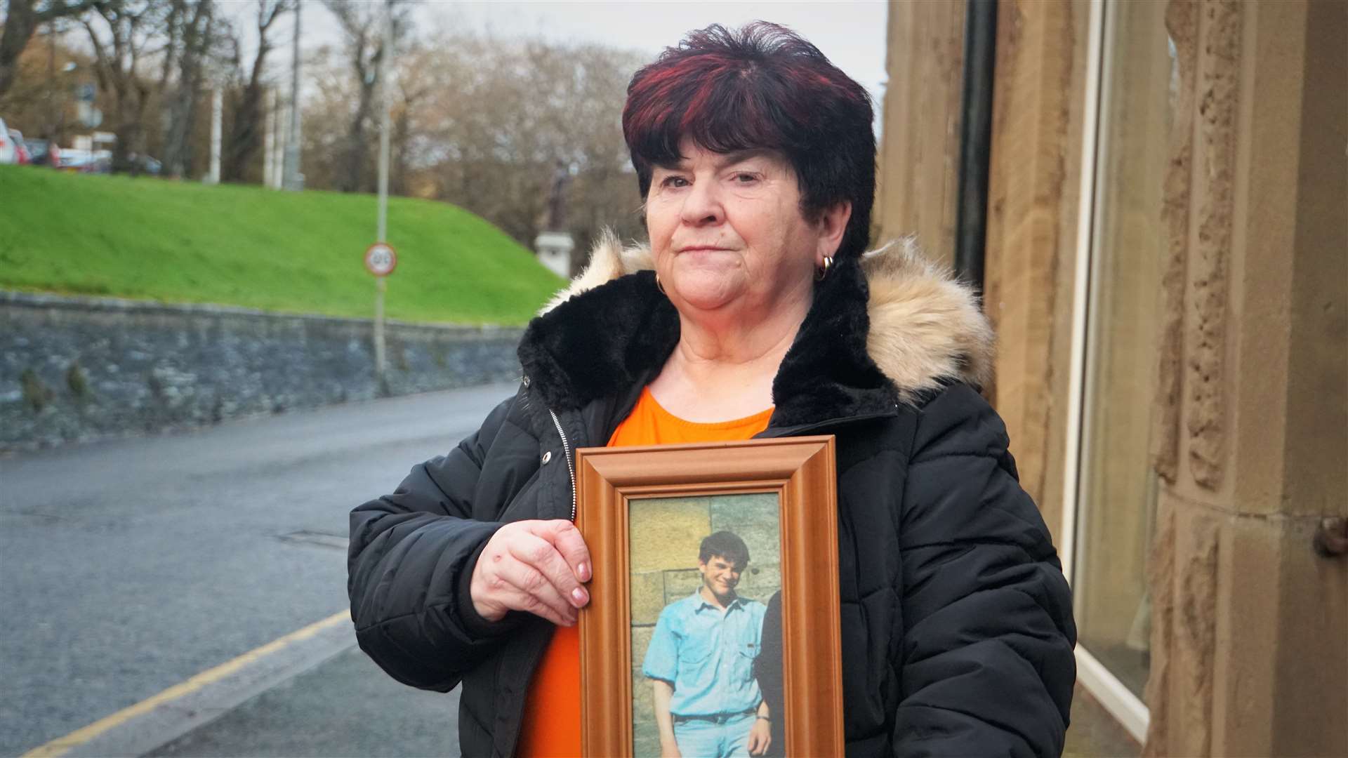 June McLeod holding a picture of her son Kevin who the family believe was murdered. Picture: DGS