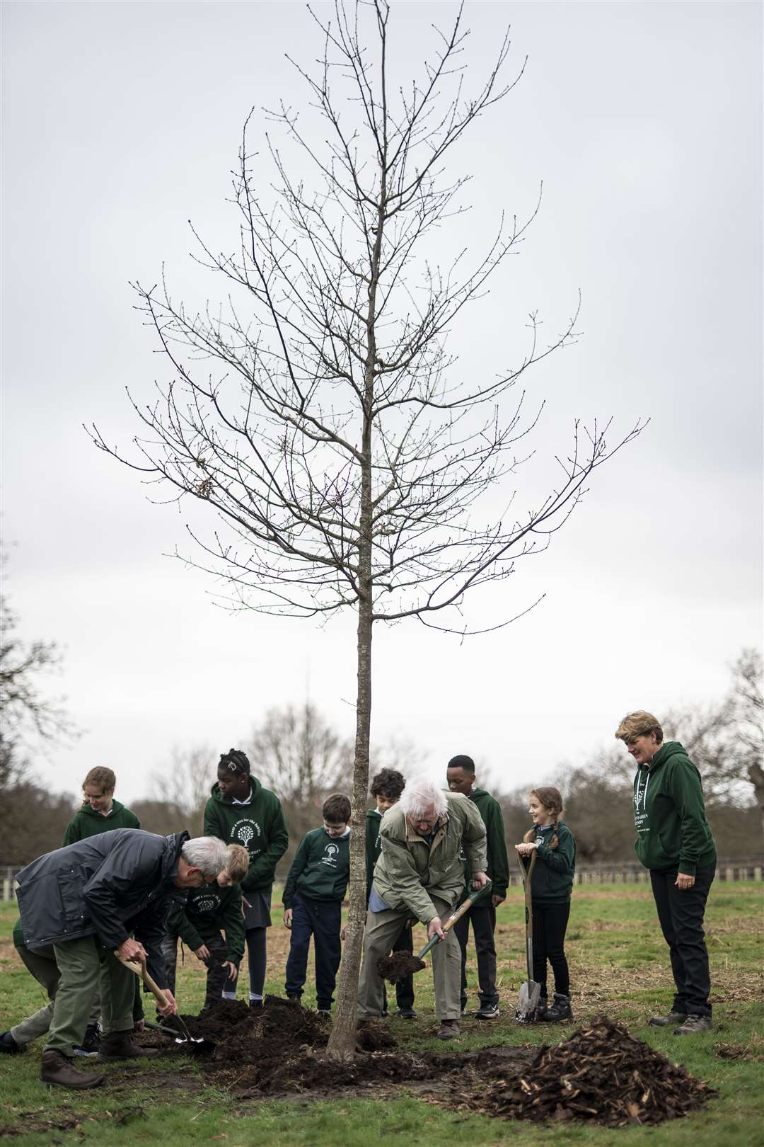 Sir David, with Clare Balding (right), plants the oak tree (Aaron Chown/PA)