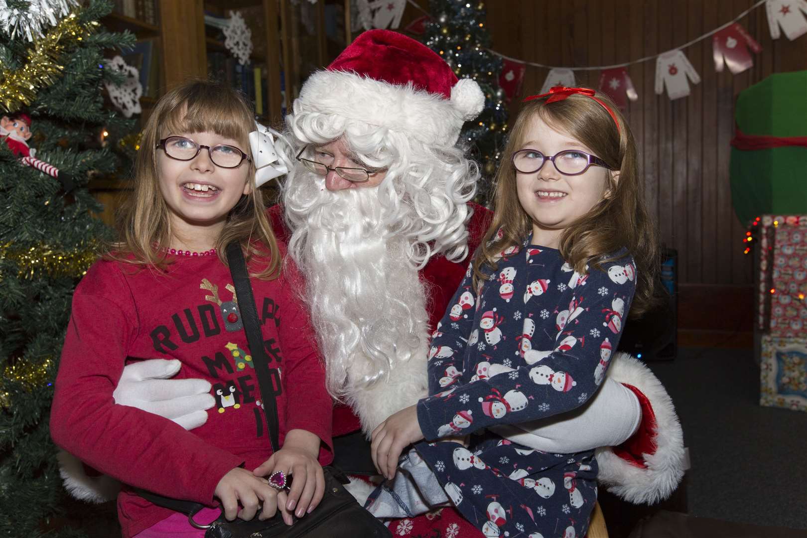 Sisters Caitlin (7), left, and Islay Swanson (6) meet Santa during the Thurso Fun Day. Picture: Robert MacDonald / Northern Studios