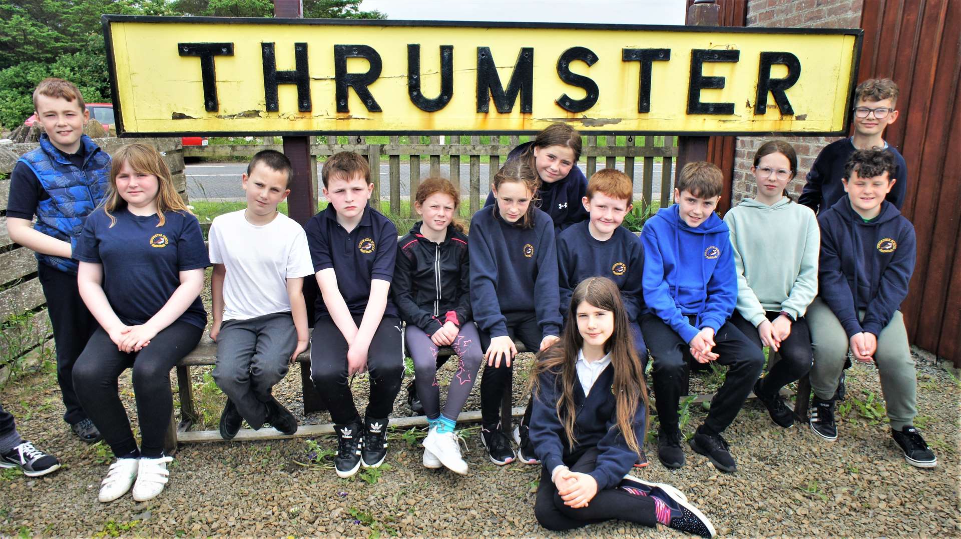 The Thrumster Primary School pupils have a portrait taken beside the refurbished station sign. Picture: DGS