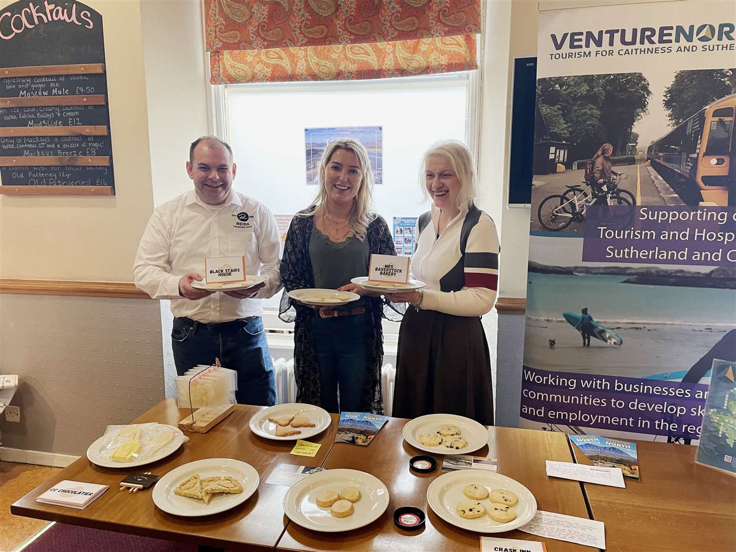Judges Gary Reid, Catriona Corbett and June McIvor holding the winning Highland Shortbread Showdown entries from Caithness and Sutherland.