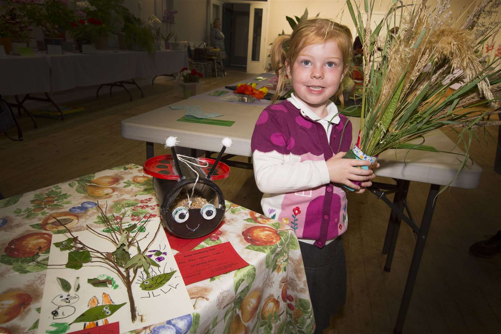 Four-year-old Ayla McAllan won the junior prizes for a decorated jar of wild grasses, a home-made bird feeder and an A4 autumn scape. Picture: Robert MacDonald/Northern Studios