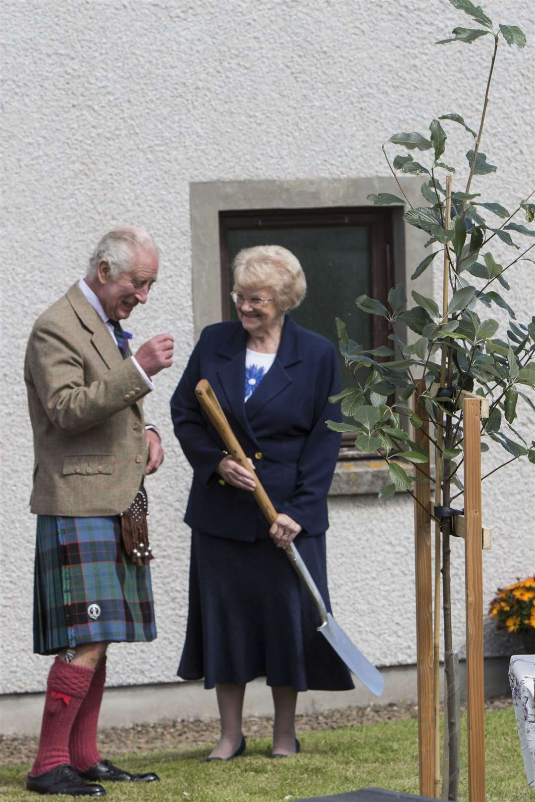 King Charles chats with Christine Shearer before planting a tree in the grounds of the Church Hall. Photo: Mandy MacDonald/Northern Studios