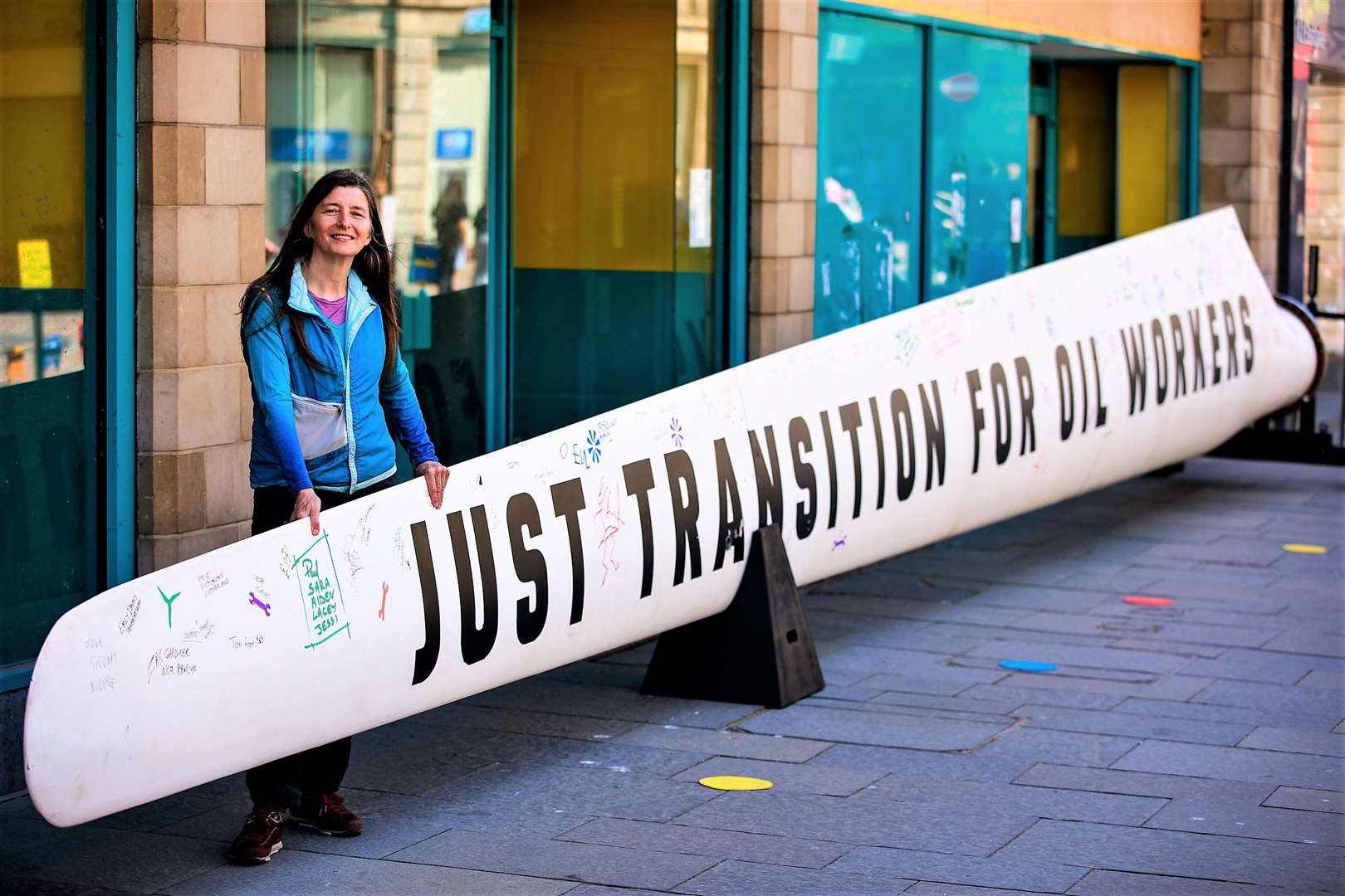 Green Party MSP for the Highlands and Islands Ariane Burgess in front of a wind turbine blade which was placed in Inverness Eastgate to campaign for a just transition for oil workers to renewable energy.