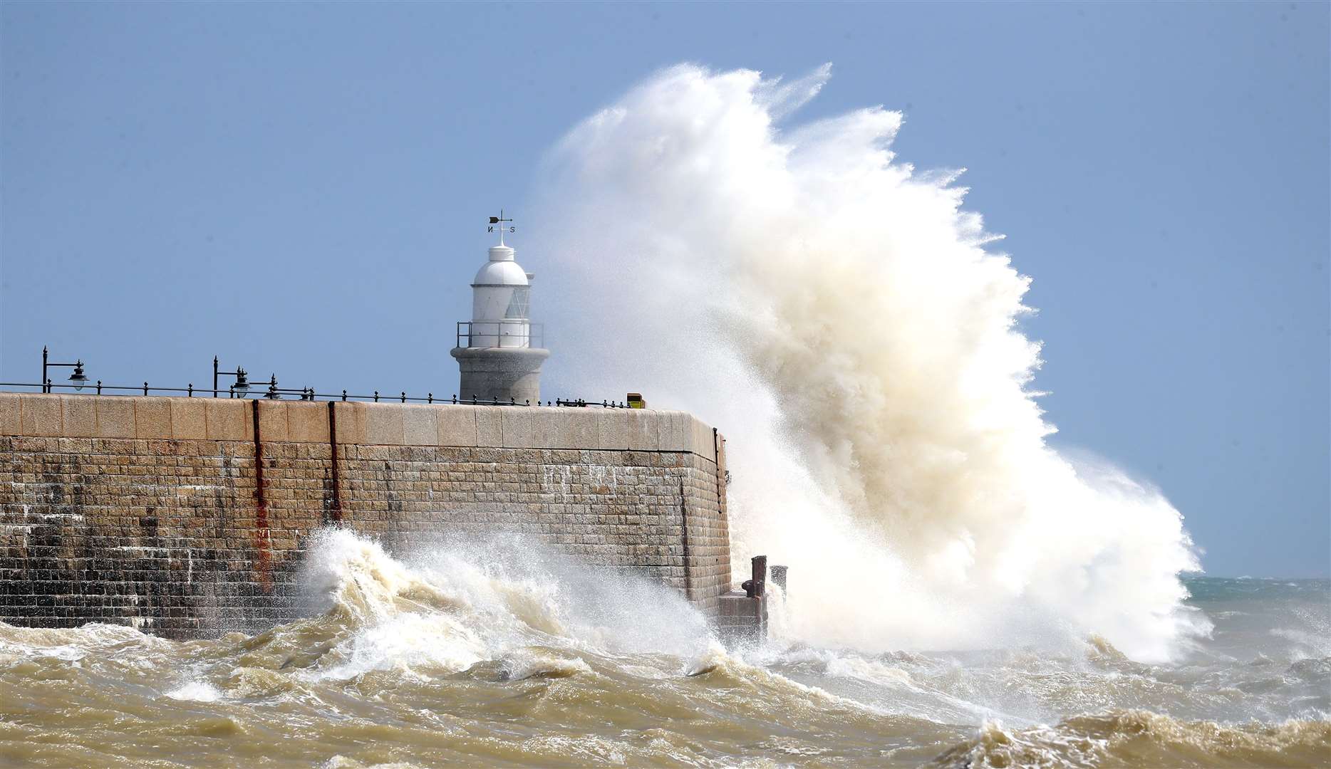 Waves crash over the harbour wall in Folkestone, Kent, on August 21 (Gareth Fuller/PA)