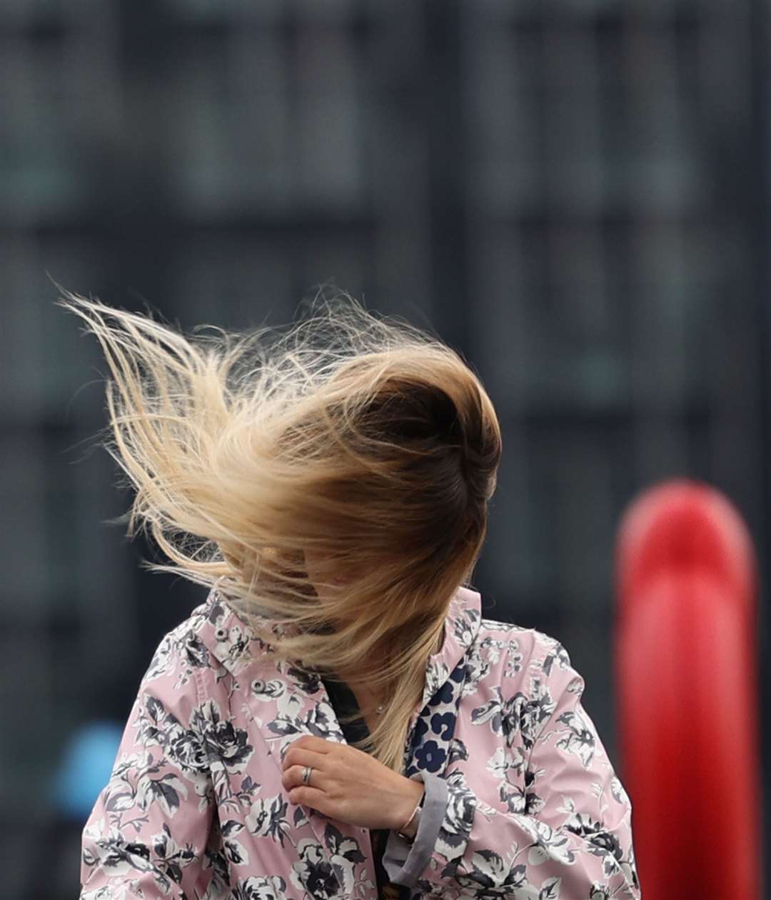 The wind catches a woman’s hair in London as Storm Francis hit the UK on August 25 (Yui Mok/PA)