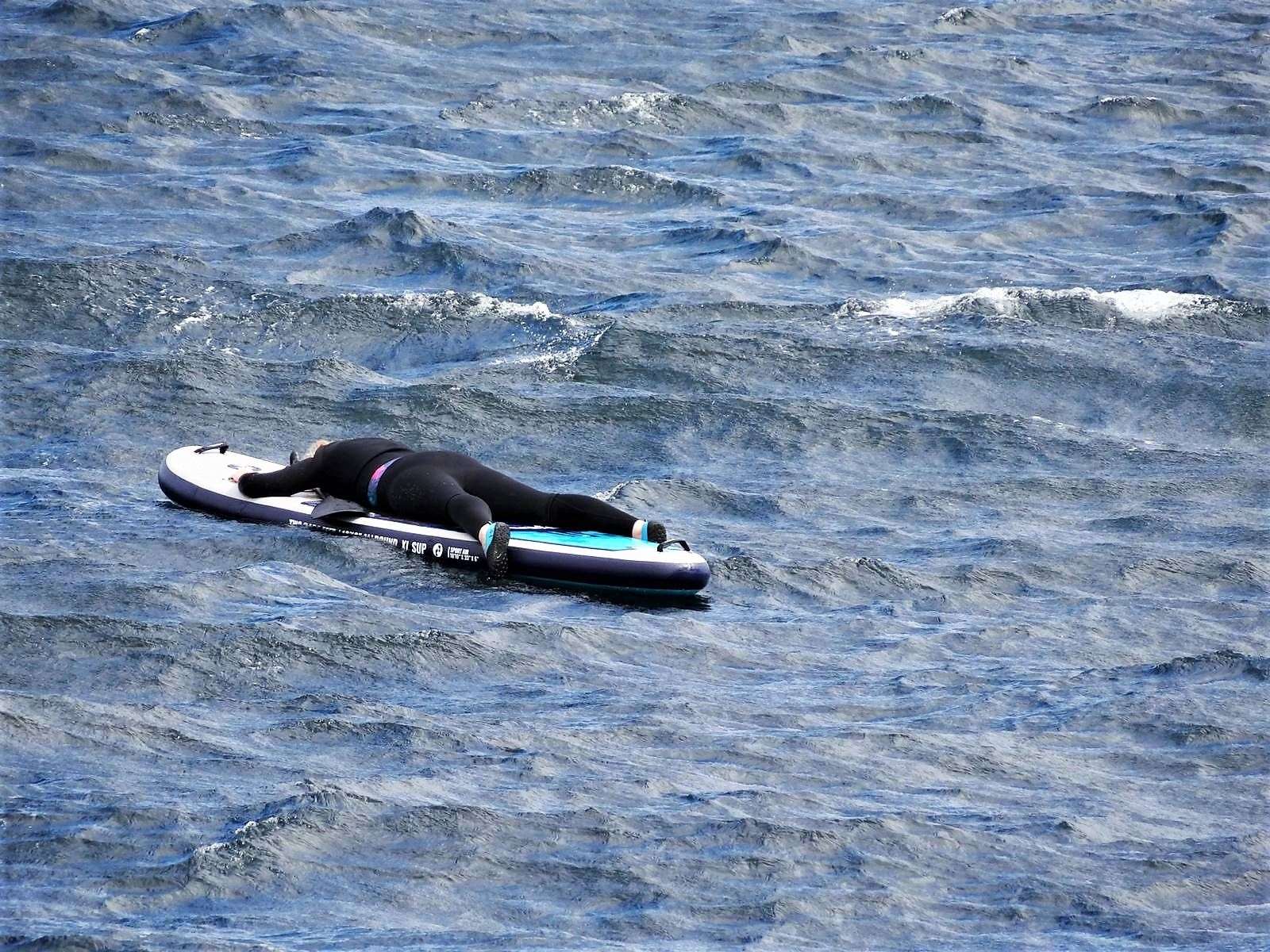 The woman is seen clinging on desperately to her paddleboard. Picture: FV Reaper
