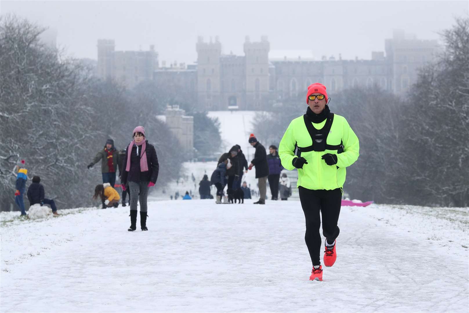 A jogger in the snow on the Long Walk at Windsor Castle, Berkshire (Jonathan Brady/PA)