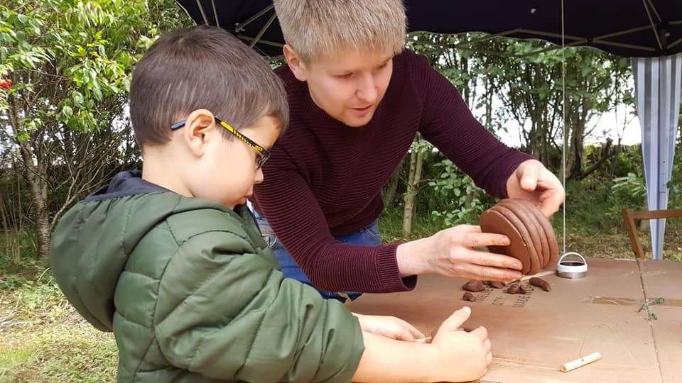 Kenneth McElroy shows a youngster the ancient art of making a coil pot from clay at a special broch-themed event in 2019. Picture: DGS