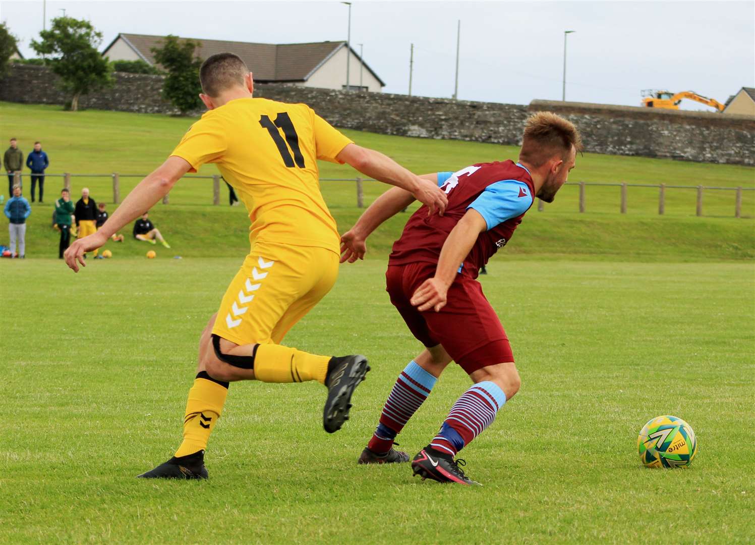 Bryan Reid (left) of Staxigoe United loses out to Pentland United's Luke Manson.