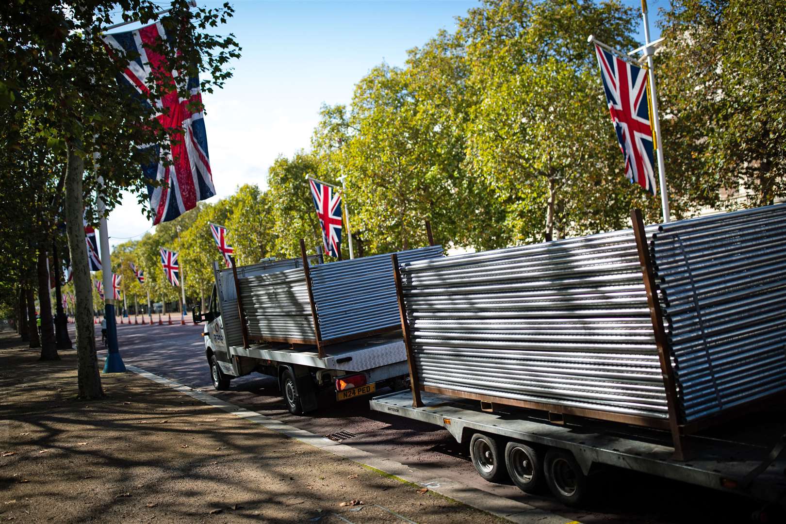 A vehicle and trailer loaded with temporary barriers on The Mall on the route of the 40th London Marathon for elite runners (Aaron Chown/PA)
