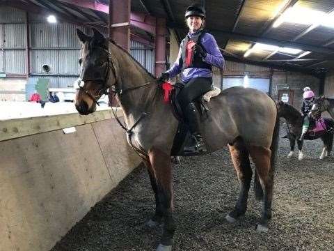 Carol Taylor proudly shows off her first jumping rosettes with her new horse Brady.