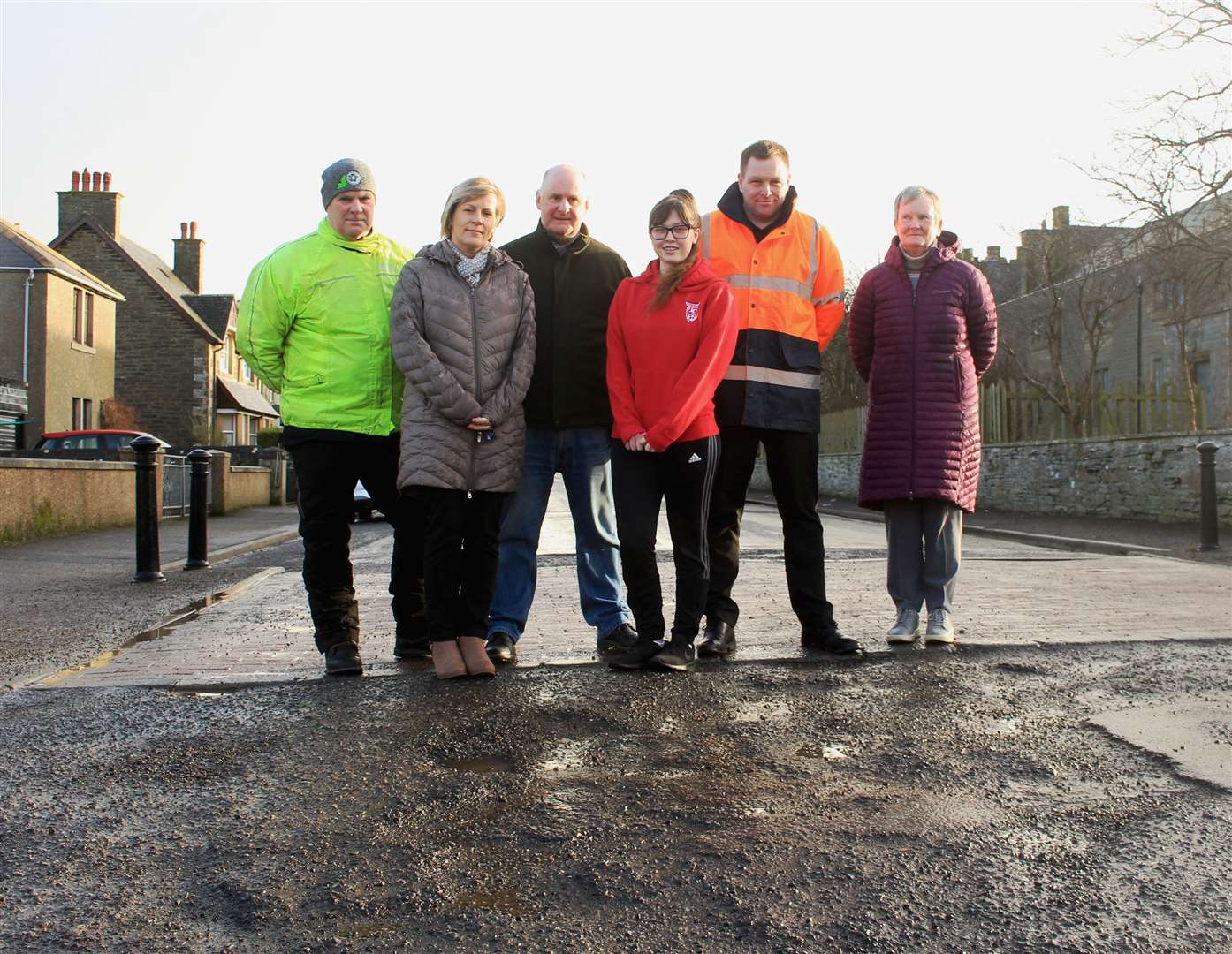 Instructors (from left) David Bremner, Debbie Aitkenhead, Adam Hendry, Gary Sinclair and Marion Mackay with 18-year-old Fearne McCarthy, who is one of Mr Sinclair’s pupils, at a patched-up section of road in West Banks Avenue this week.