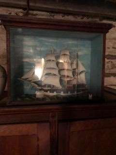 The model ship was contained in a glass cabinet.