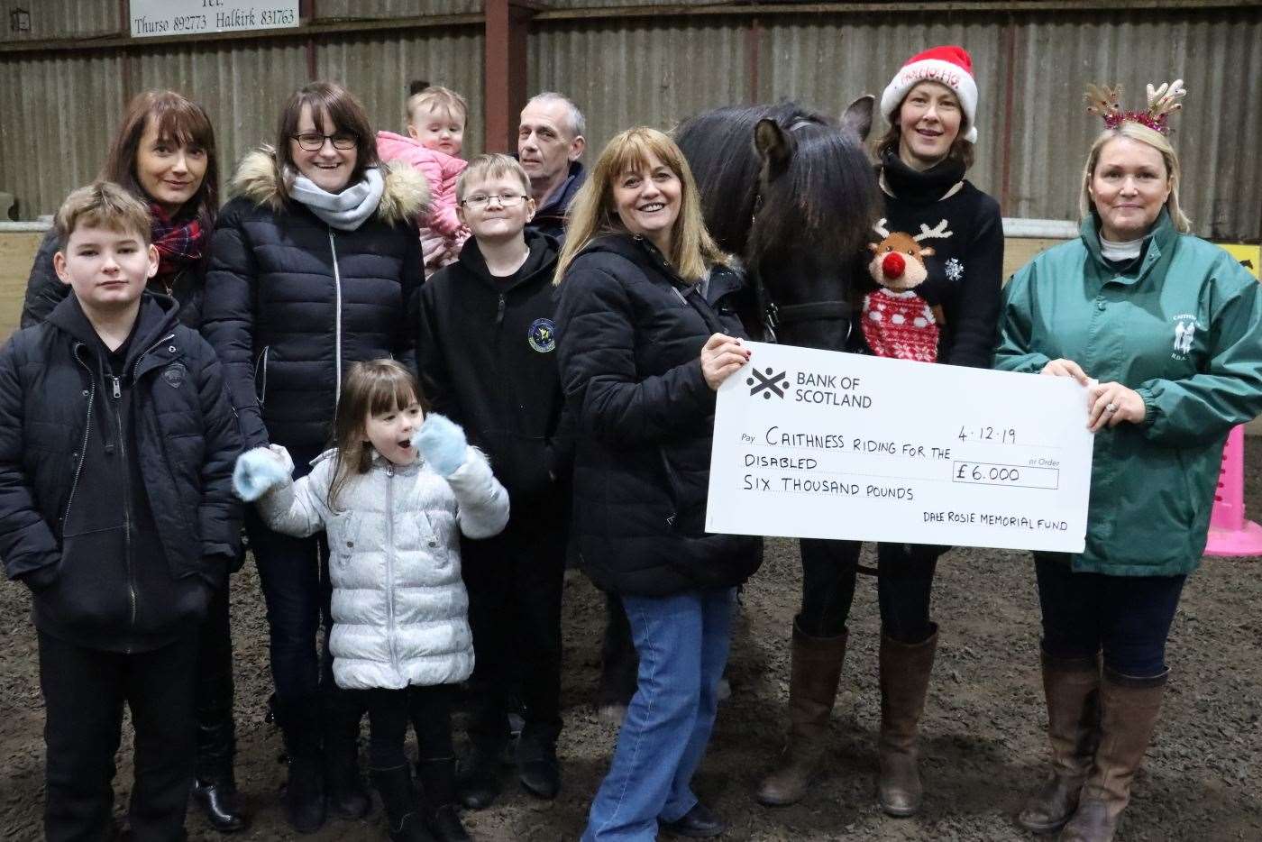 Members of the Rosie family handing over a cheque for £6000 to the Caithness RDA group chairperson Judith Miller (right), with volunteer Liz Hewitson looking on. Picture: Neil Buchan