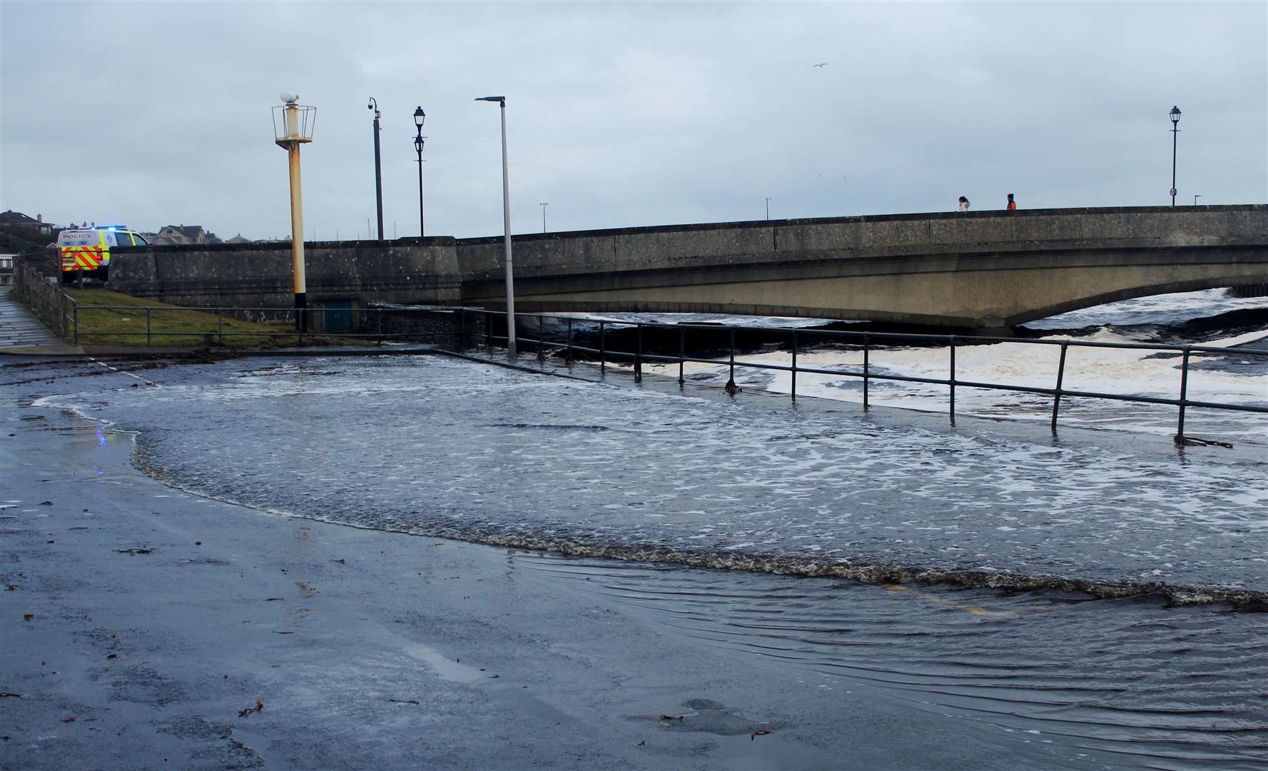 Water flowing up from the river onto Wick's Market Street on Sunday. Picture: Alan Hendry