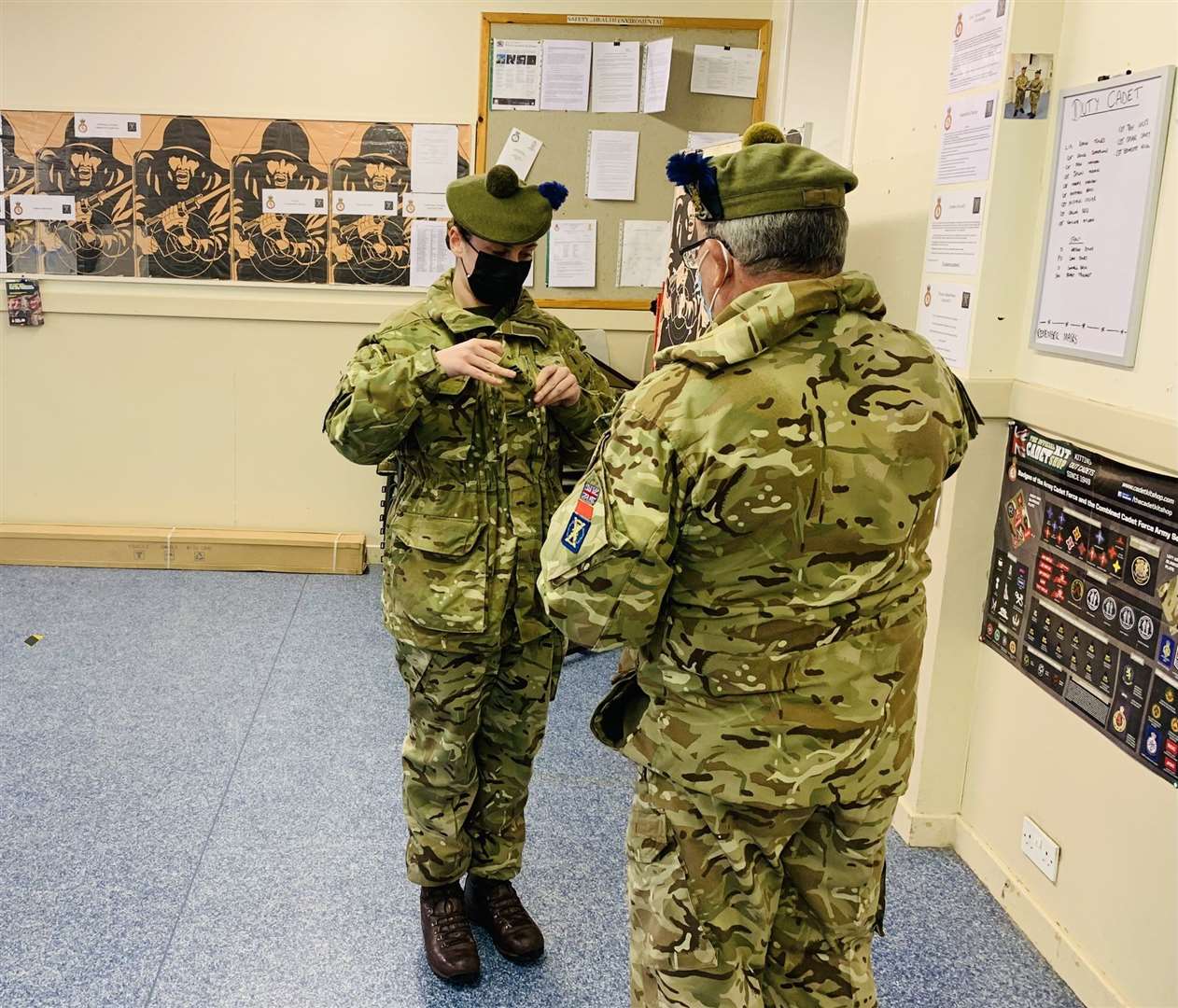 Lani8 Jones (left) receives her Sergeant stripes from Caithness Company Commander Major McLean after completing her training.
