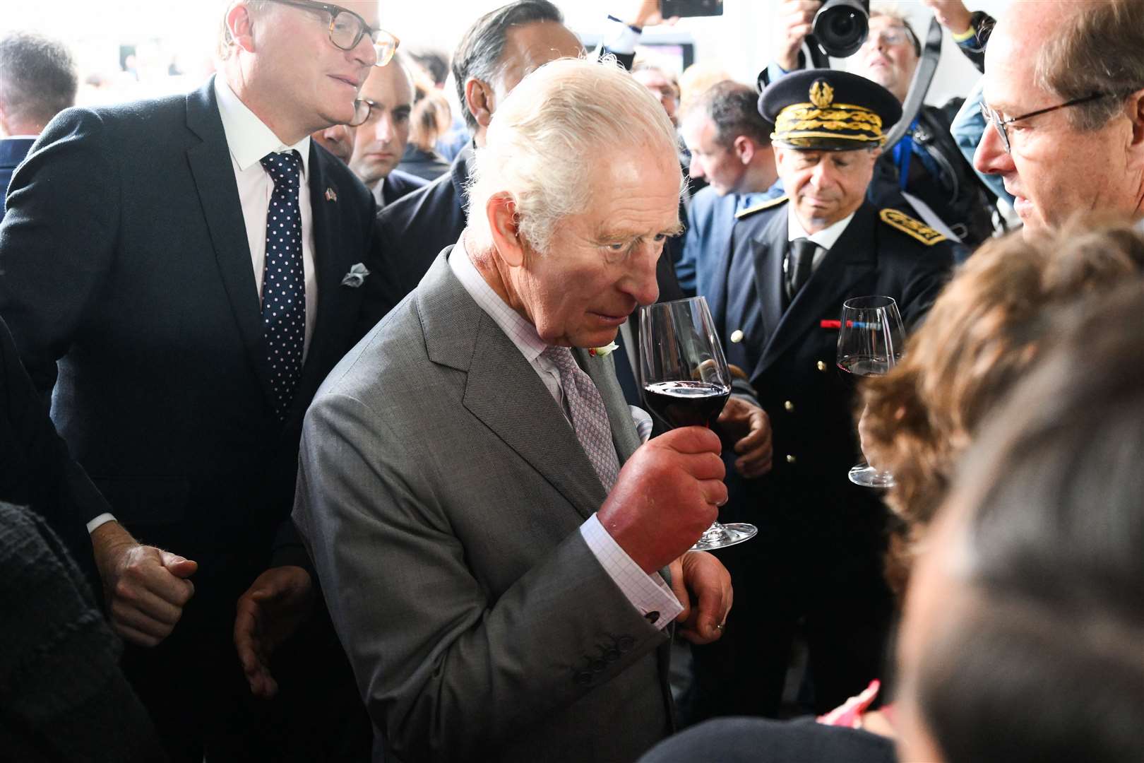 Charles smelling a glass of red wine on day three of the state visit to France (Daniel Leal/PA)