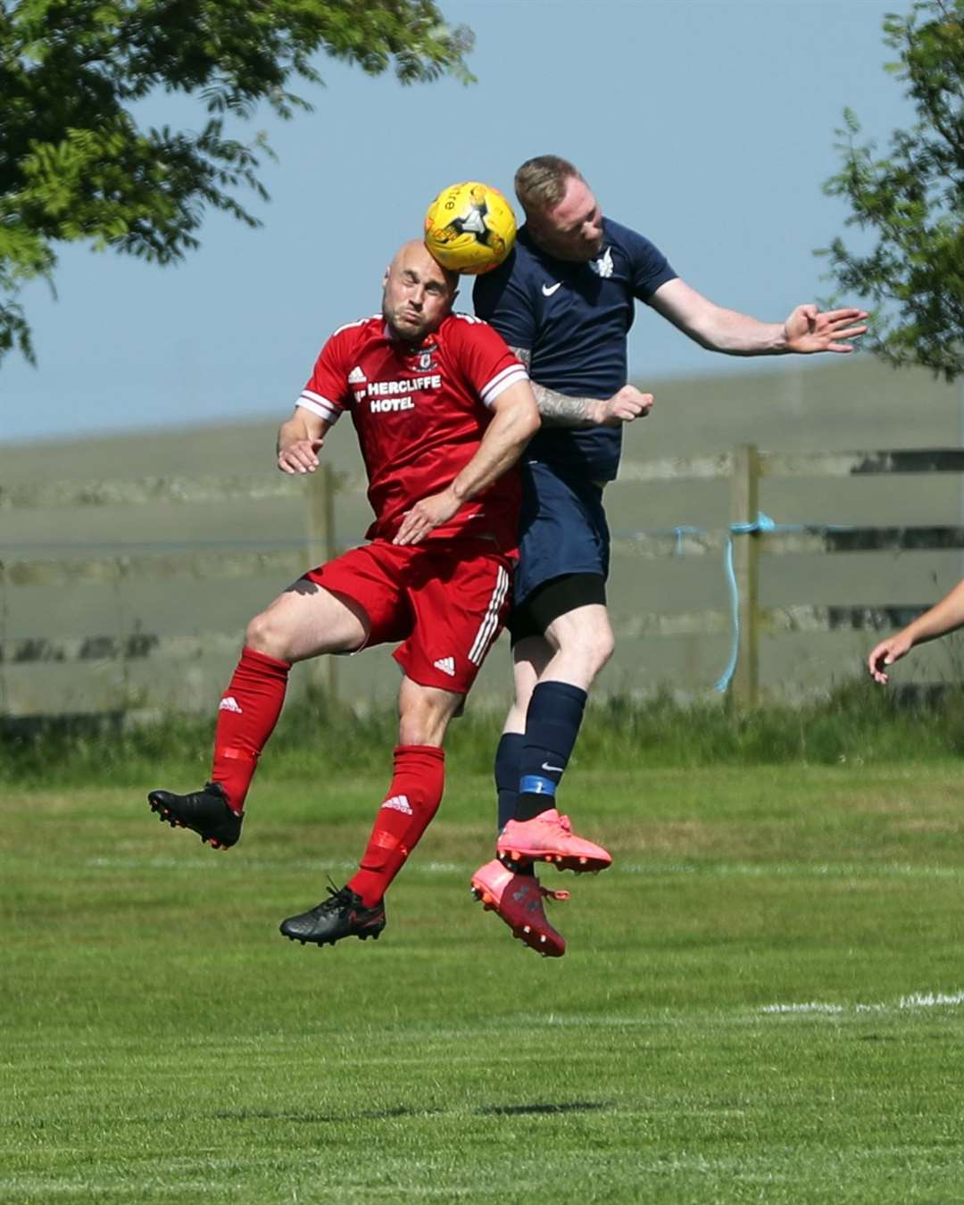 Wick Groats striker Sandy Sutherland in an aerial duel with Aidan Reid of High Ormlie Hotspur in the Eain Mackintosh Cup final. Picture: James Gunn
