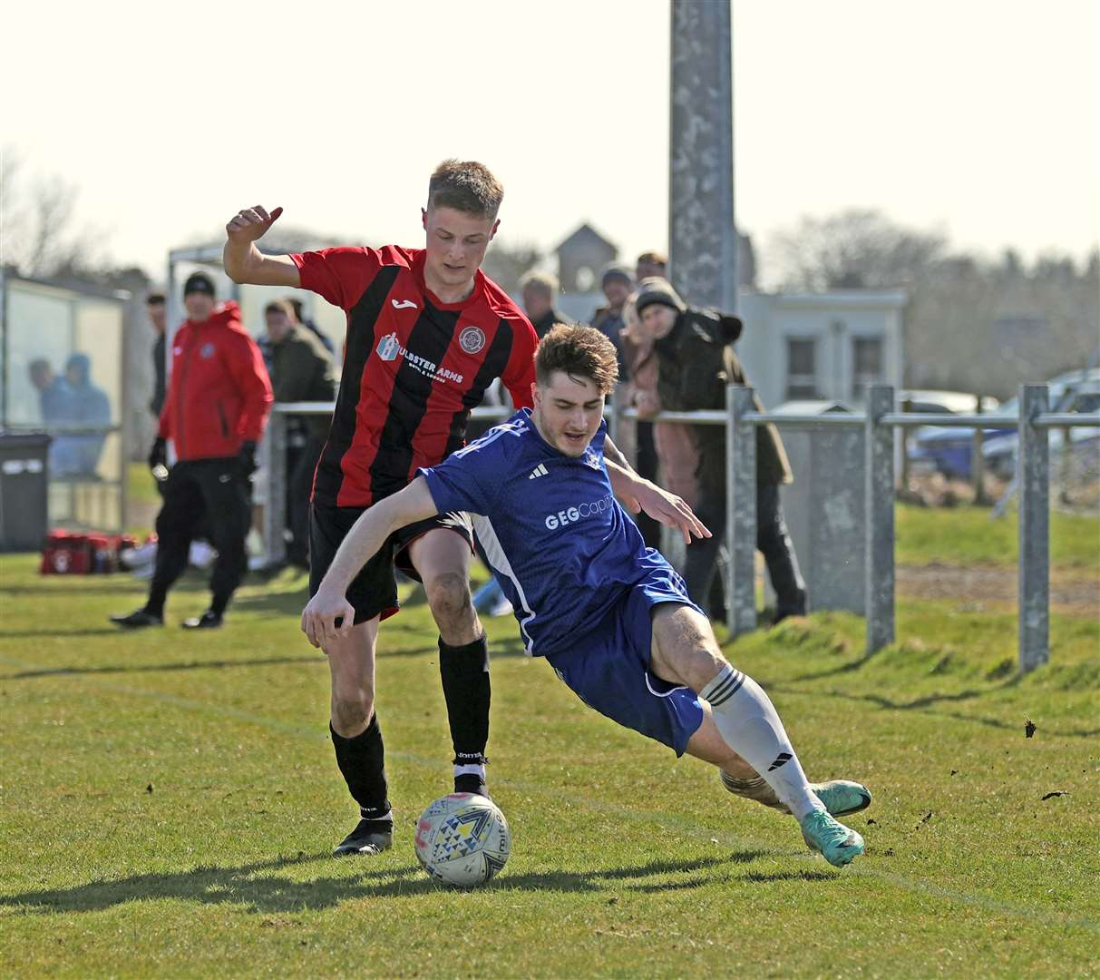 Halkirk United's James Mackintosh tries to get past Invergordon defender Riley Mackenzie. Picture: James Gunn