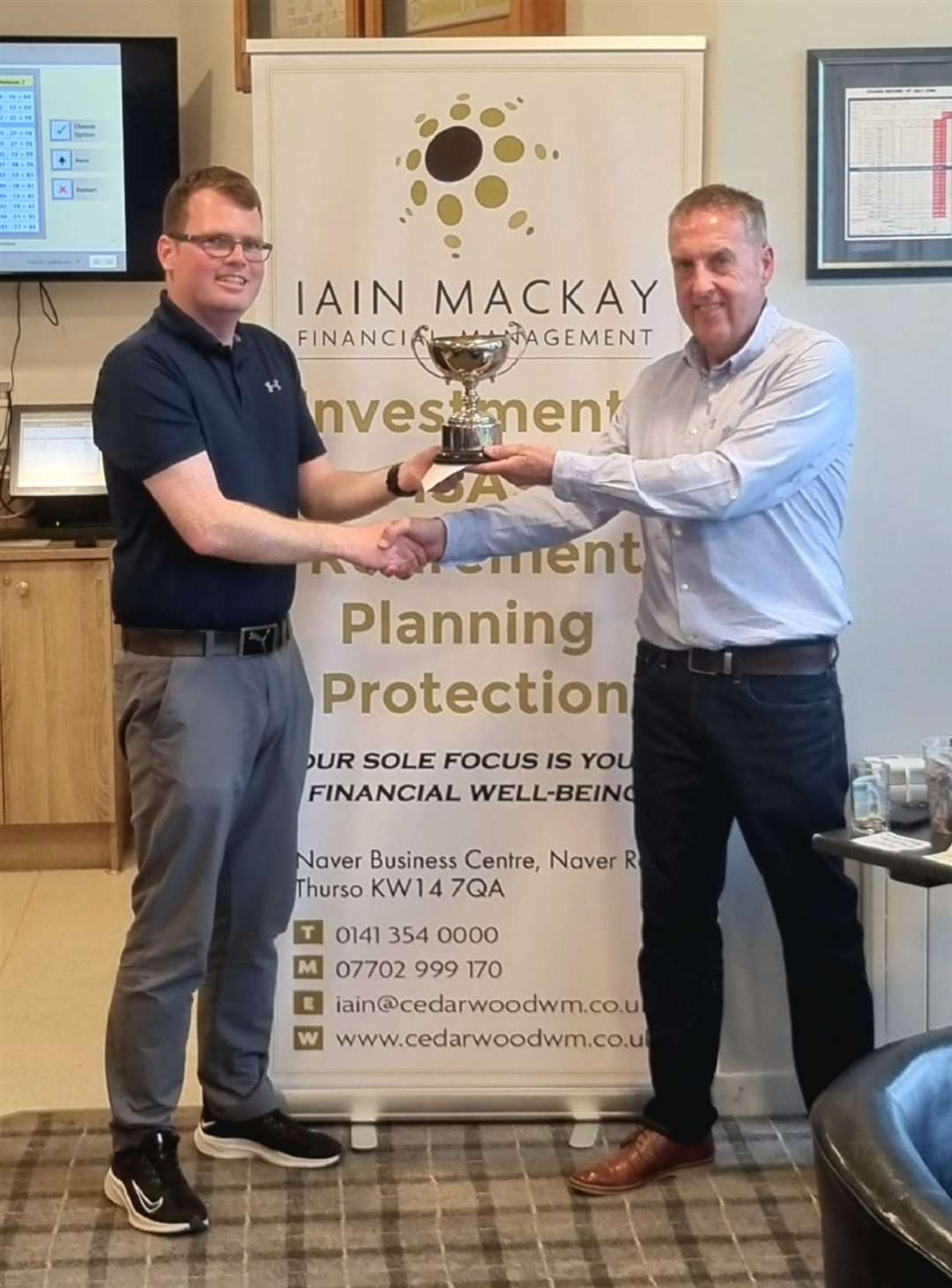 Scratch winner Brent Munro receiving his trophy from Iain Mackay (Iain Mackay Financial Management).