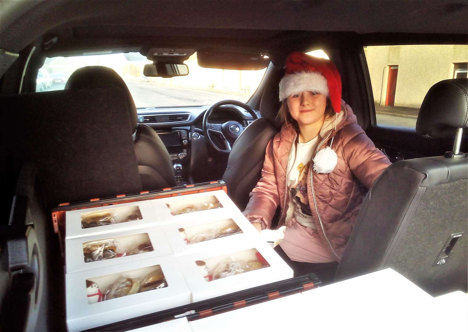 Young Emily Henderson setting off to help deliver the afternoon tea hampers to local pensioners and customers.