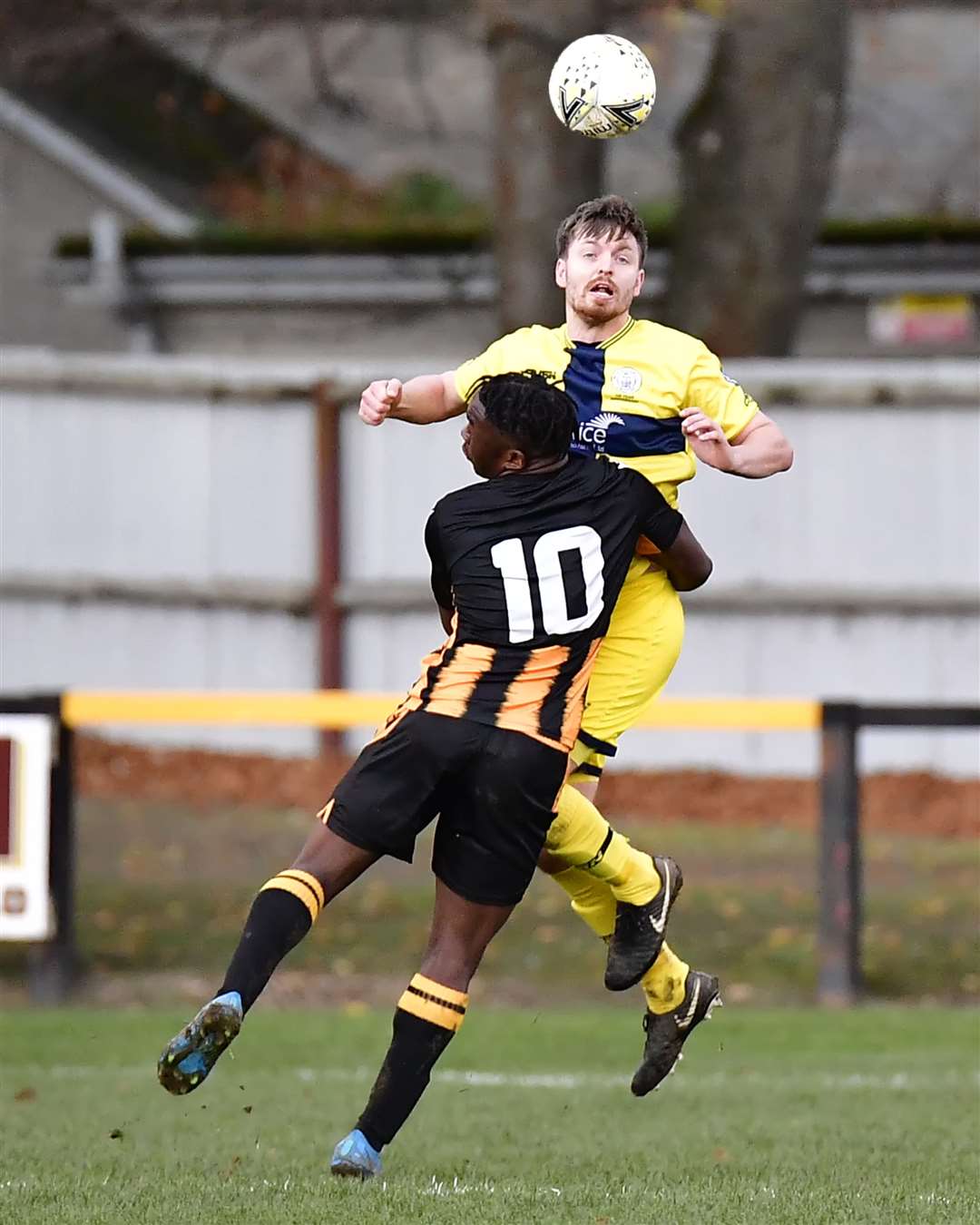 Huntly's Michael Dangana holds down Wick Academy defender Andy Hardwick. Picture: Mel Roger