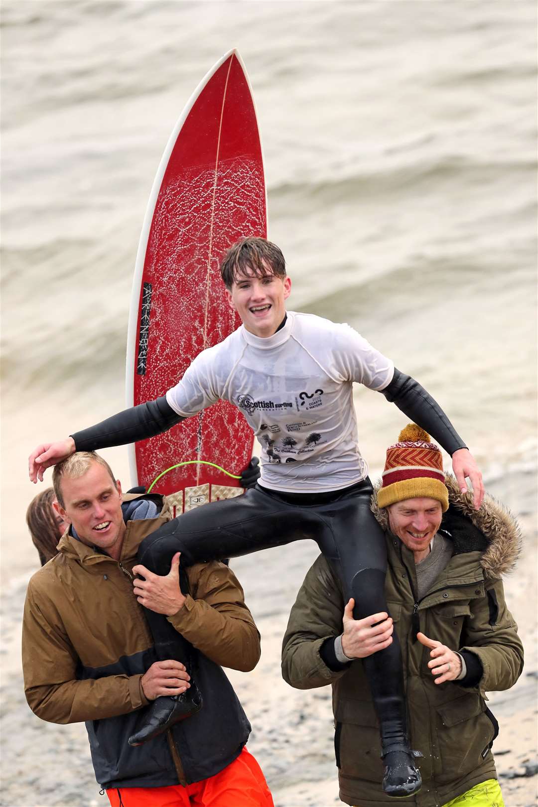 Craig McLachlan is carried aloft by former Scottish champion Mark Boyd (left) and fellow North Shore Surf Club member Scott Main after becoming the 2021 open title holder. Picture: James Gunn