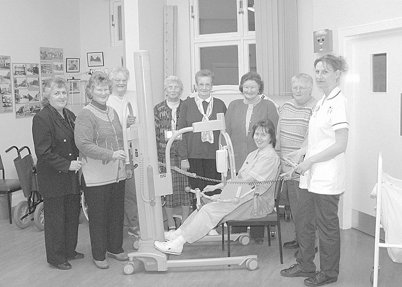 Members of the League of Friends of Dunbar Hospital were pictured handing over a new chair hoist this week in 2003. It was accepted by staff nurse Isobel Sutherland, while auxiliary nurse Sheila Geddes tried it out. Picture: Mario Luciani