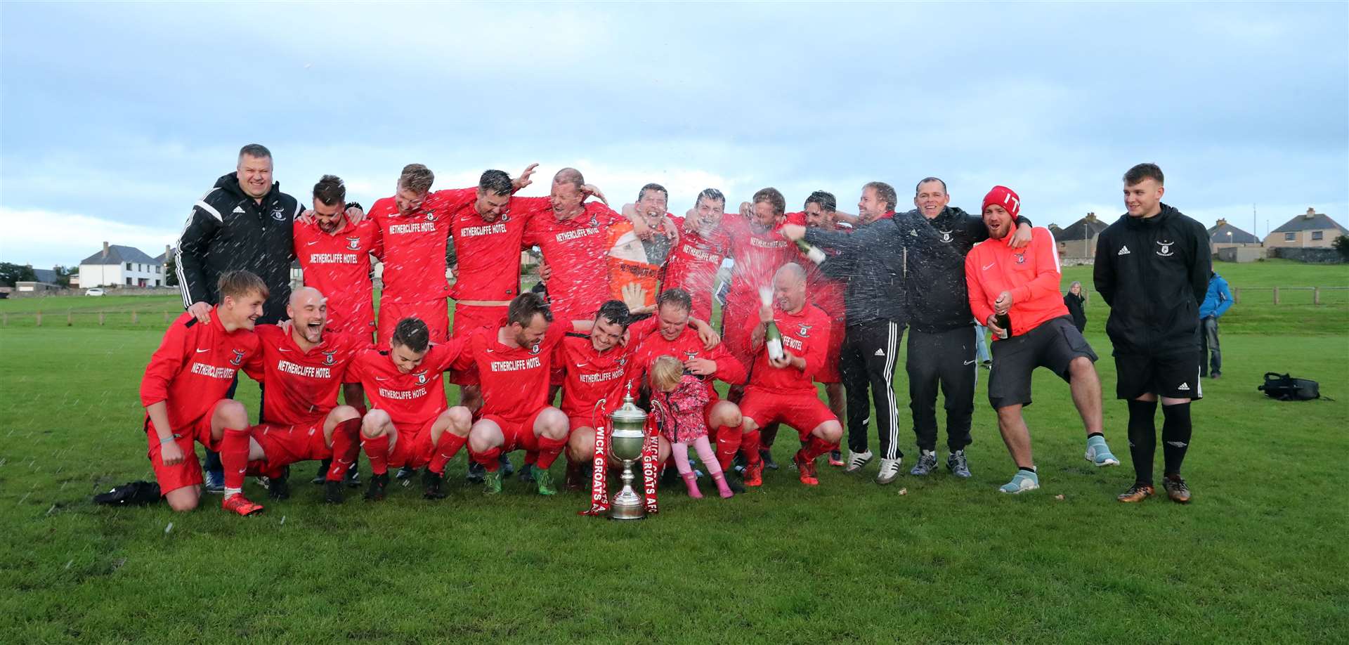 The champagne corks fly as Wick Groats celebrate winning the 2019 CAFA Division ONe League title. Picture: James Gunn