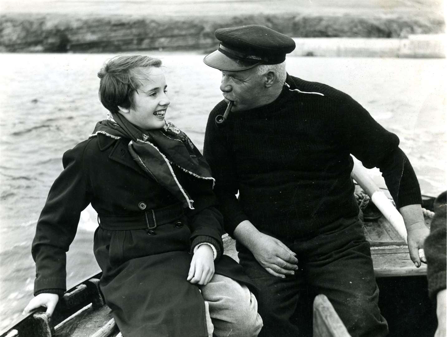 An image from the chapter about Stroma showing Andrew Manson, the head of the last family living on the island, at the helm of the yawl Celtic. He can be seen chatting to Shona Adams, the daughter of the Wick photographer John Adams who took the picture in the 1950s. Picture submitted by John Manson, Scrabster