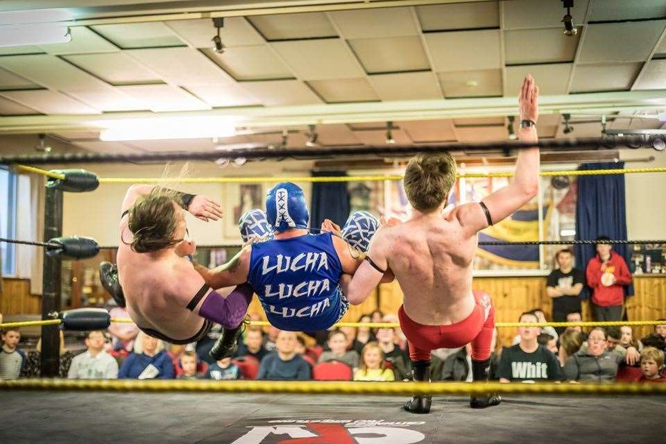 Lucha DS, centre, performs a backward slam on Lad Chapman and Glen Dunbar during the Northern Fights wrestling bout at Thurso. Picture: Studiograff