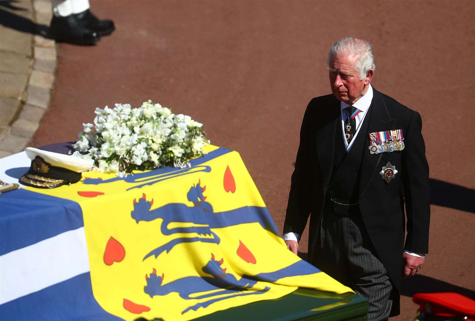 The Prince of Wales walks behind the Duke of Edinburgh’s coffin, outside St George’s Chapel (Hannah McKay/PA)