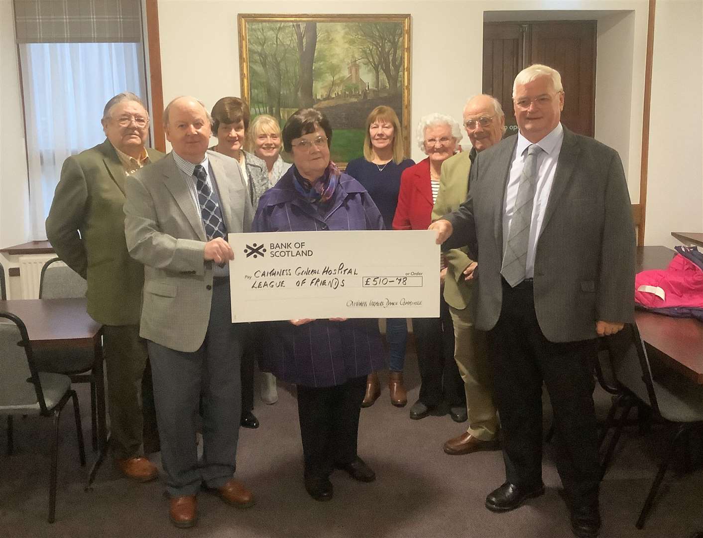 Lorette Mackay, treasurer of the Caithness General Hospital League of Friends, accepting the cheque from members of the Caithness Farmers Dance Committee, with other League of Friends representatives looking on.