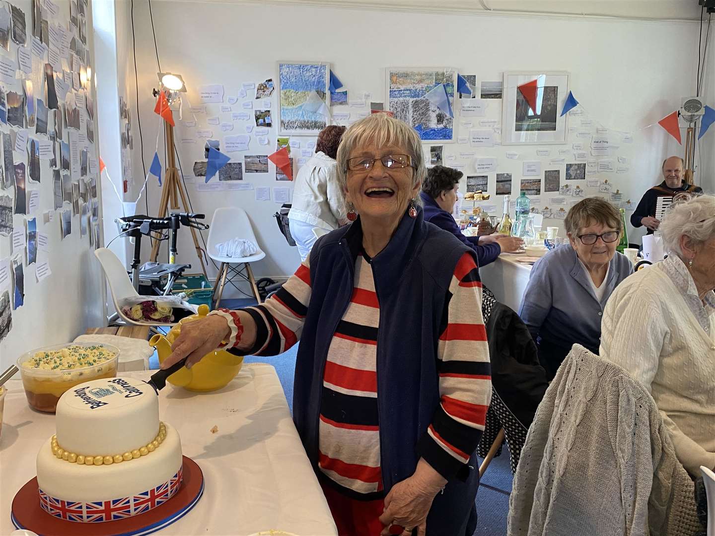 Befriendee June Dyson, who was 90 last week, cuts the cake.