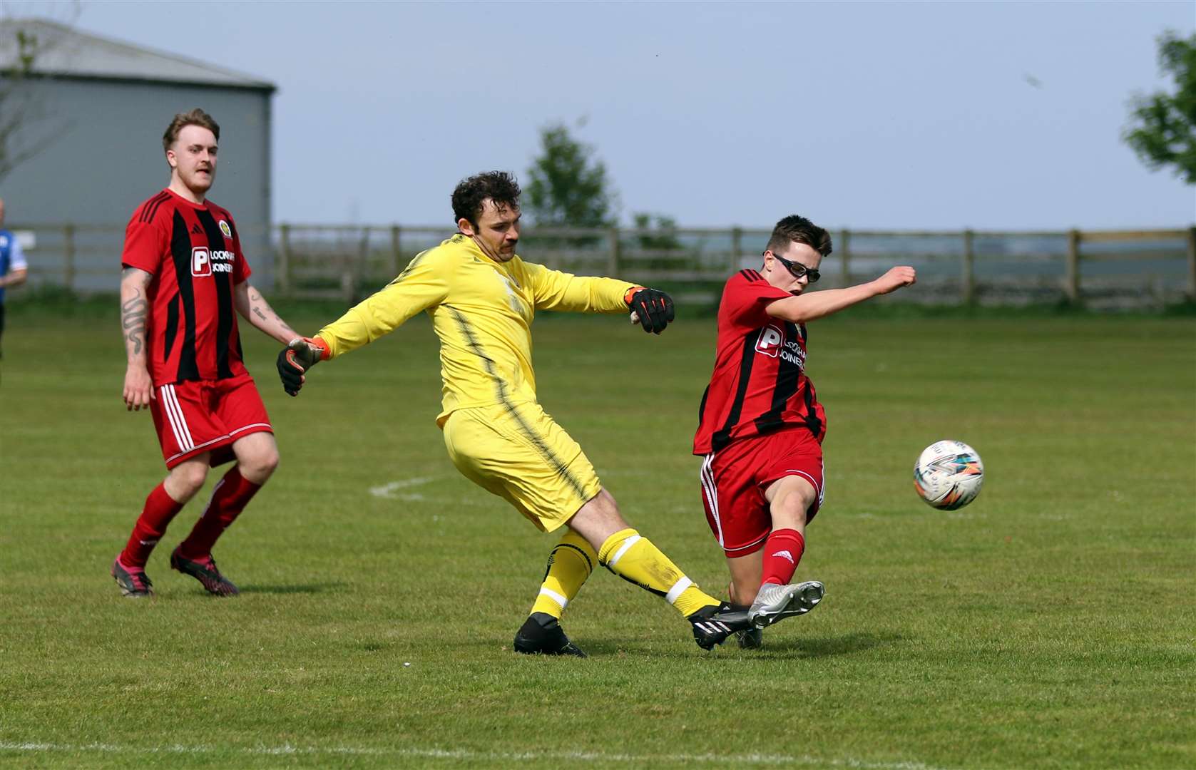 William Godding just clears the danger from Halkirk's Matthew Cook at Recreation Park. Picture: James Gunn