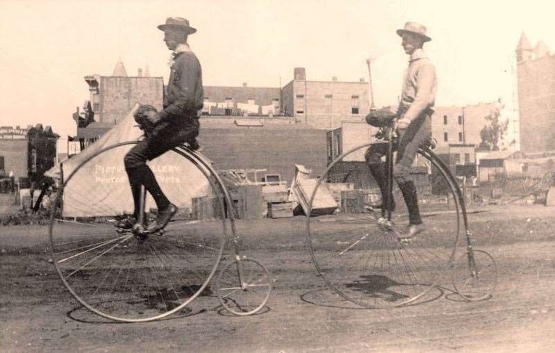 Two men ride penny-farthings in Santa Ana, California, in 1886.