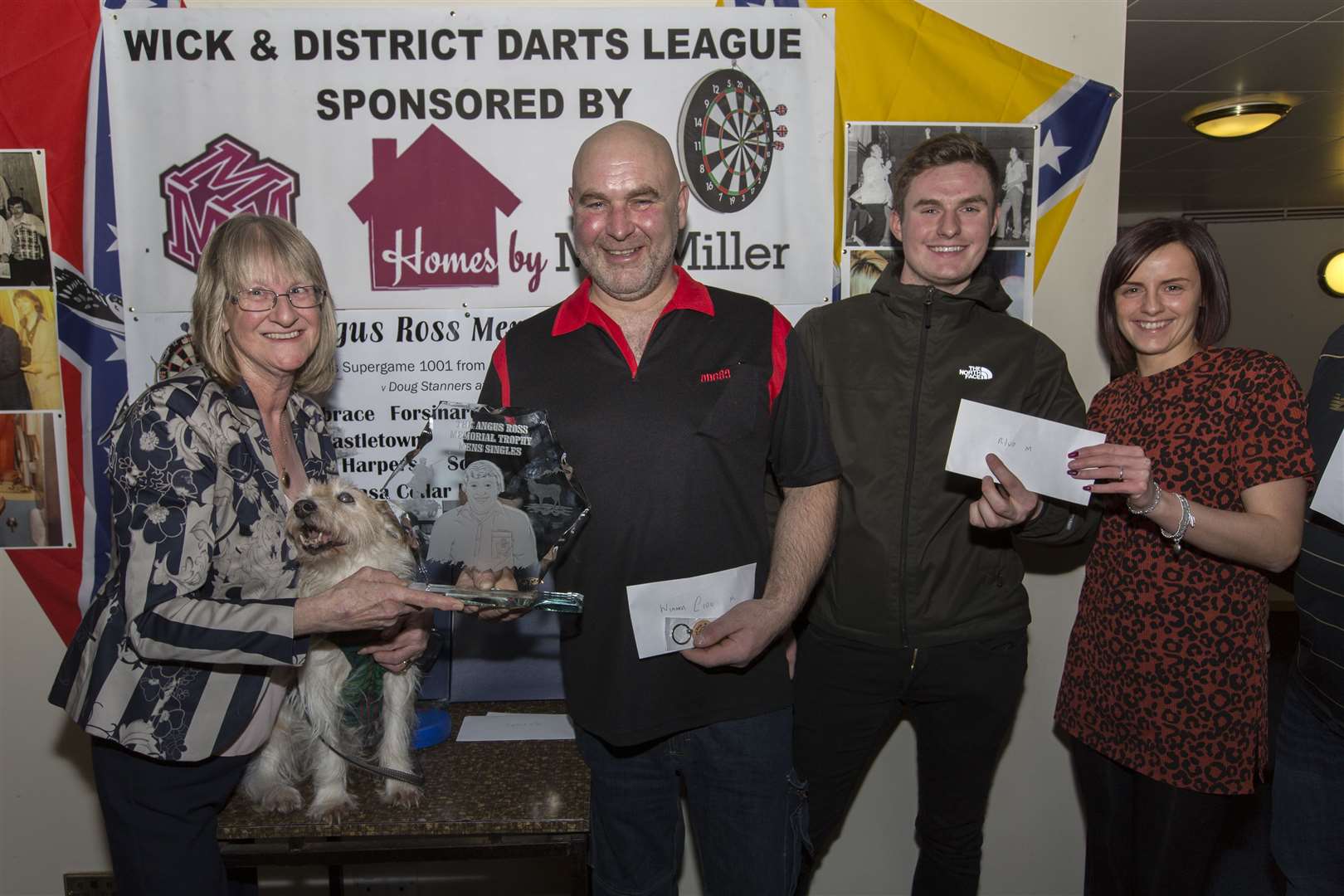 Seaview's Kevin Macgregor, winner of the men's section of the Angus Ross memorial competition, receives his trophy from Angus's widow Marina, accompanied by his dog Jocky. The runner-up was Damon Meikle (Seaforth) who received his prize from Nicola Sinclair on behalf of Harper's Bar. Picture: Robert MacDonald / Northern Studios