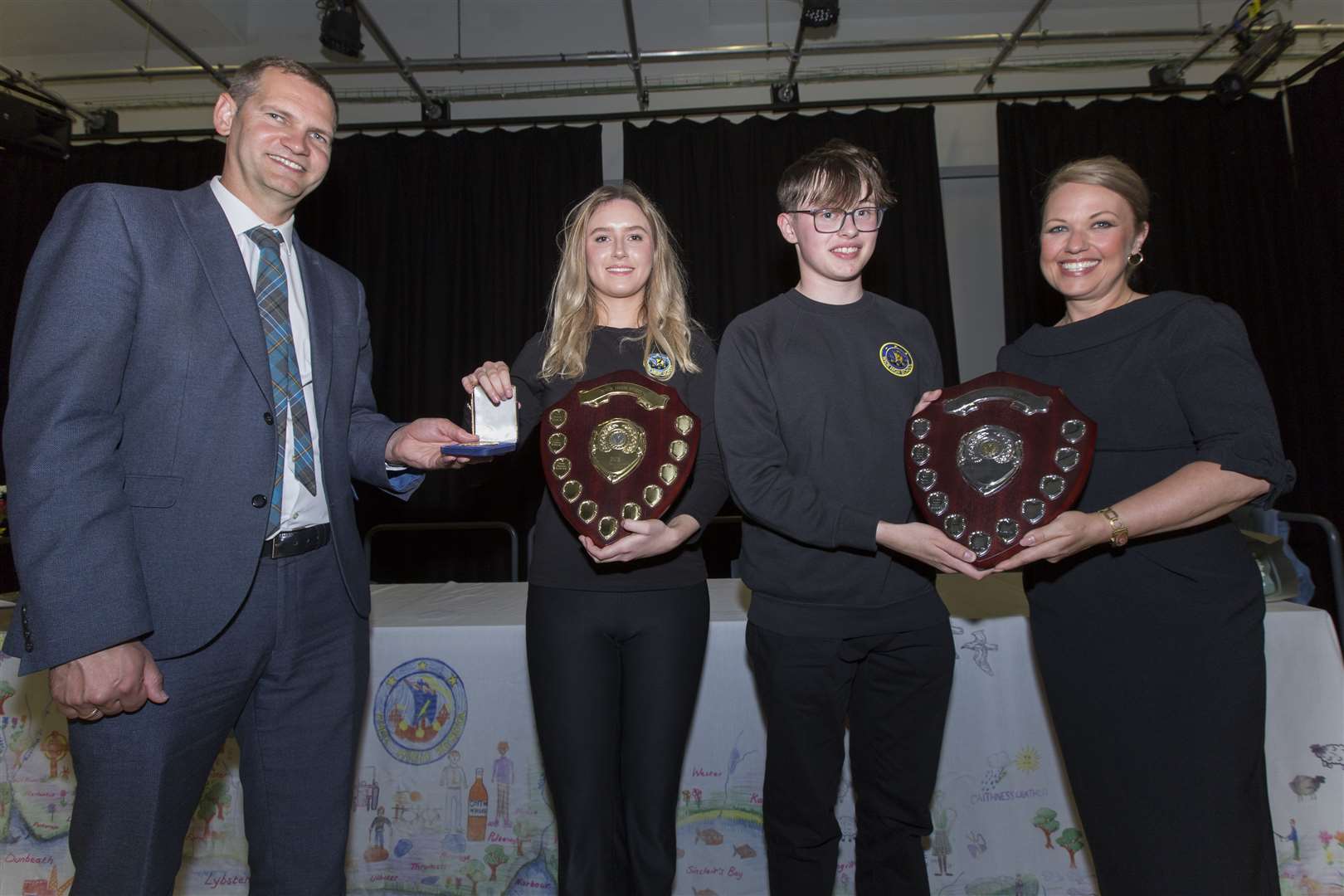 Rachel Swanson, Wick High School Dux for the past academic year, receives her medal from head teacher Sebastion Sandecki, while guest speaker Gail Ross presents the runner-up award to Ewan Begg. Picture: Robert MacDonald/Northern Studios