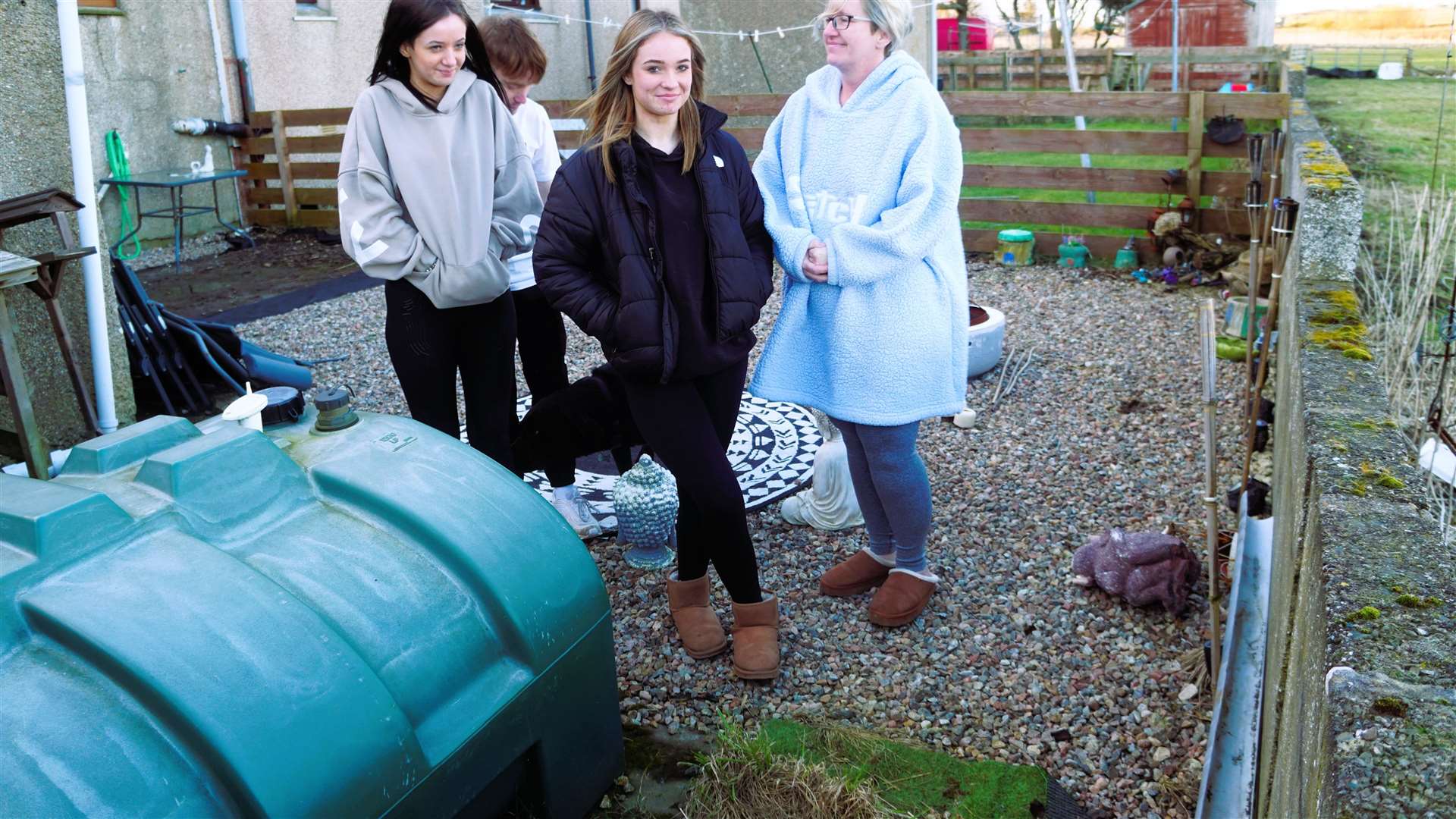 The family beside the oil tank which is almost empty after thieves struck twice in two weeks. Donna is fitting a secure lock and will install security cameras at the site. Picture: DGS