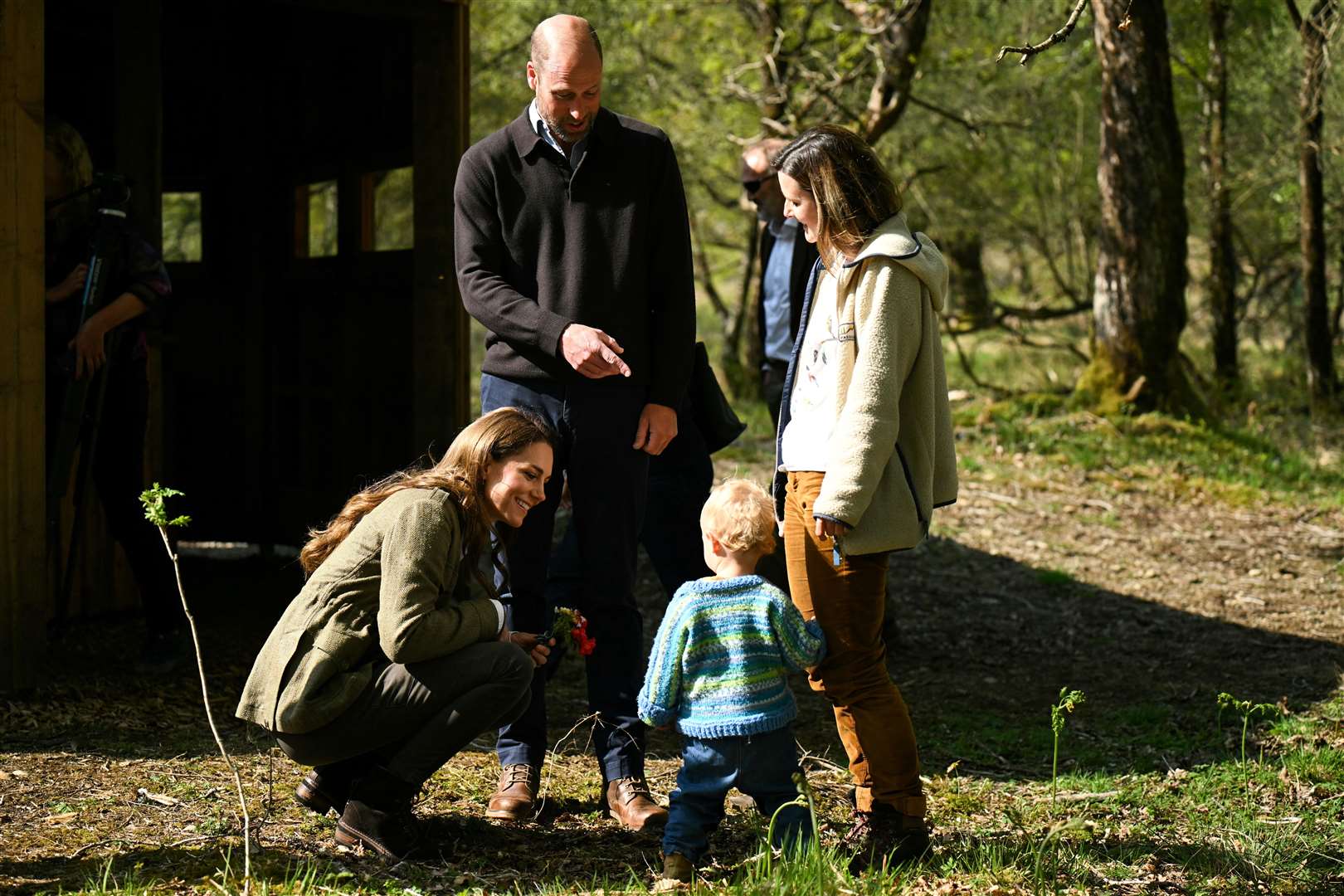 William and Kate speak to a child from the Ardura Acorns group during a visit to the Ardura Community Forest (Oli Scarff/PA)