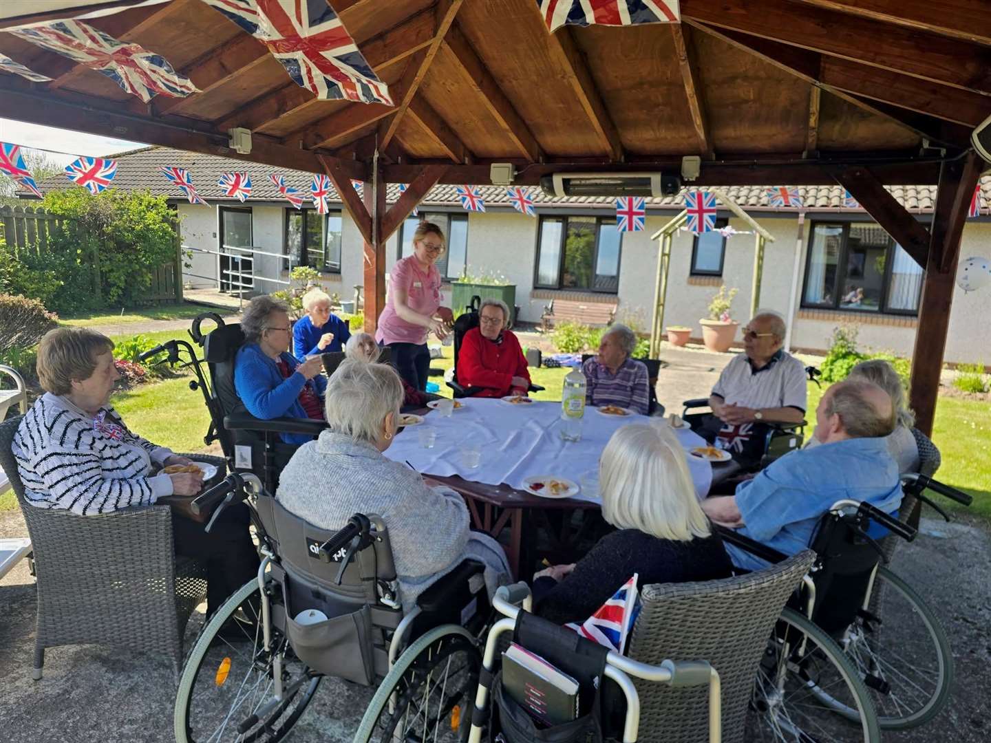 Residents enjoying their VE Day anniversary lunch alfresco.