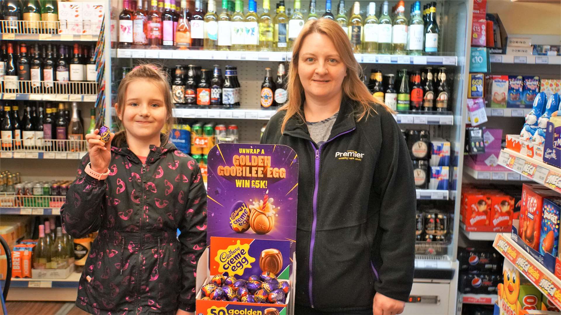 D&S Henderson's shop owner Sonya Henderson with her daughter Emily beside the Cadbury's Creme Egg stand that the winning egg was in.
